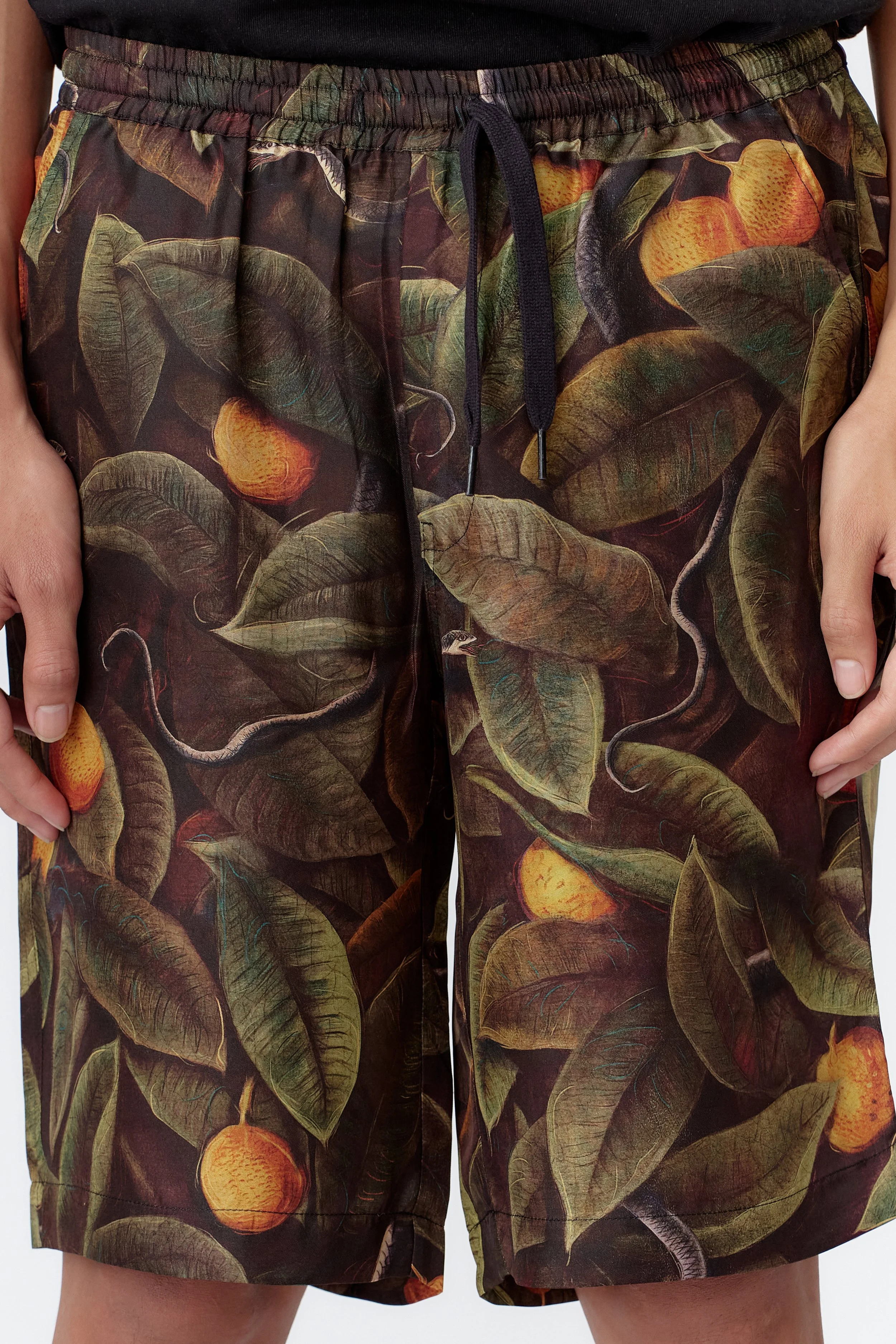 close-up Snaker limited edition 100% silk satin twill short sleeve shirt featuring green foliage and serpents