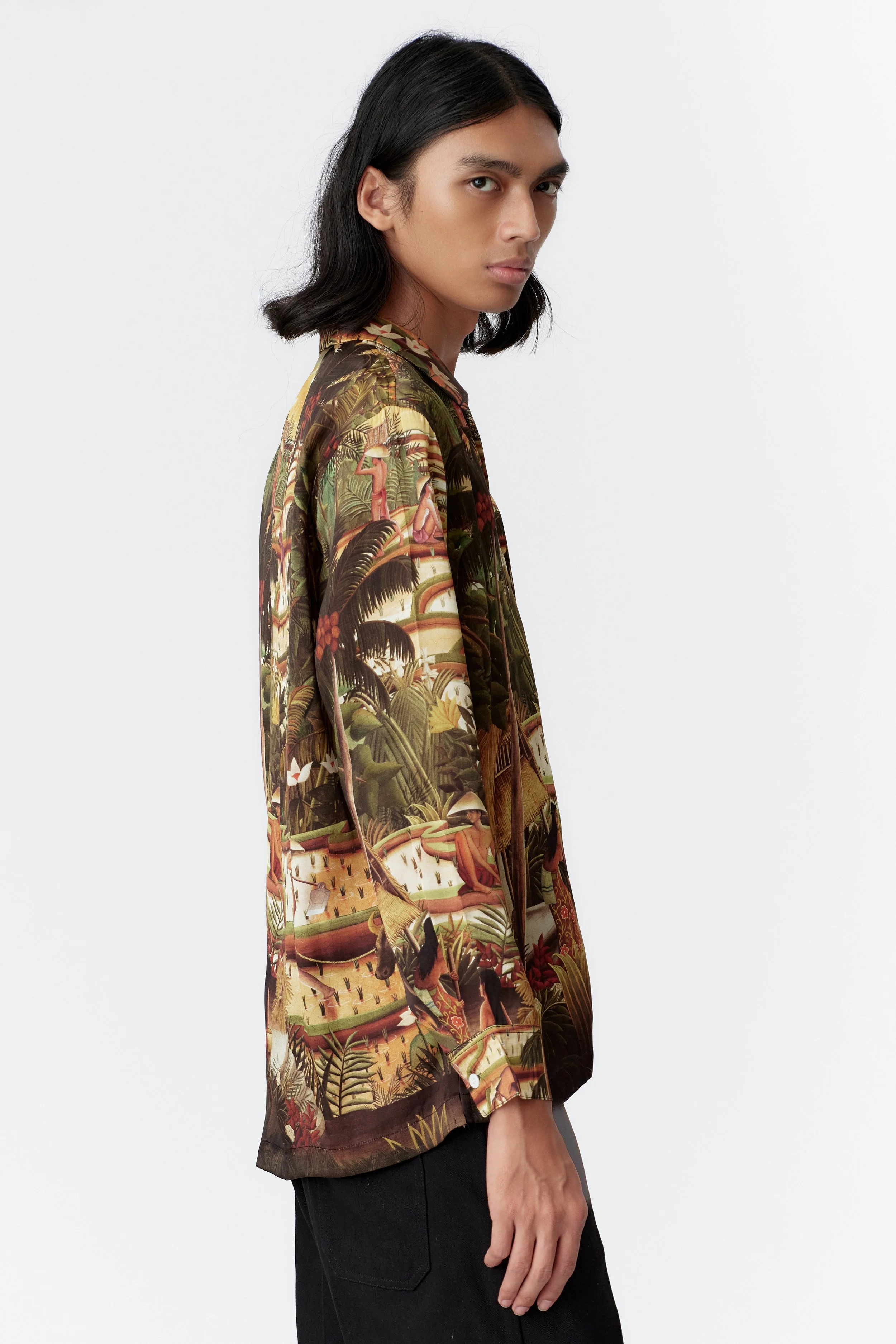 Long sleeve detail with mother of pearl buttons and multi-tone tropical print on green silk satin.