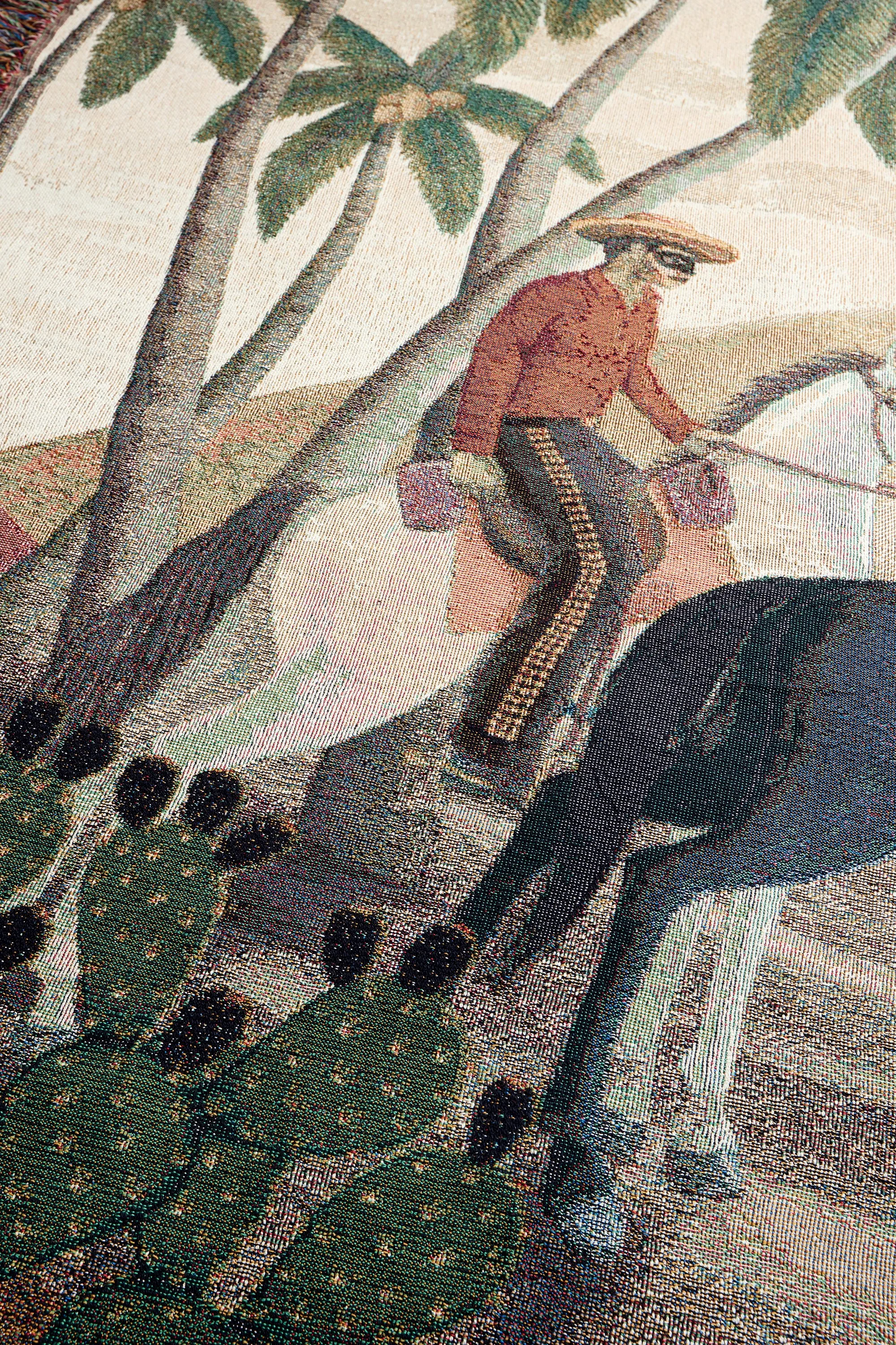 Close-up woven detail of man on horse beneath palm tree from the Bandito limited edition blanket.