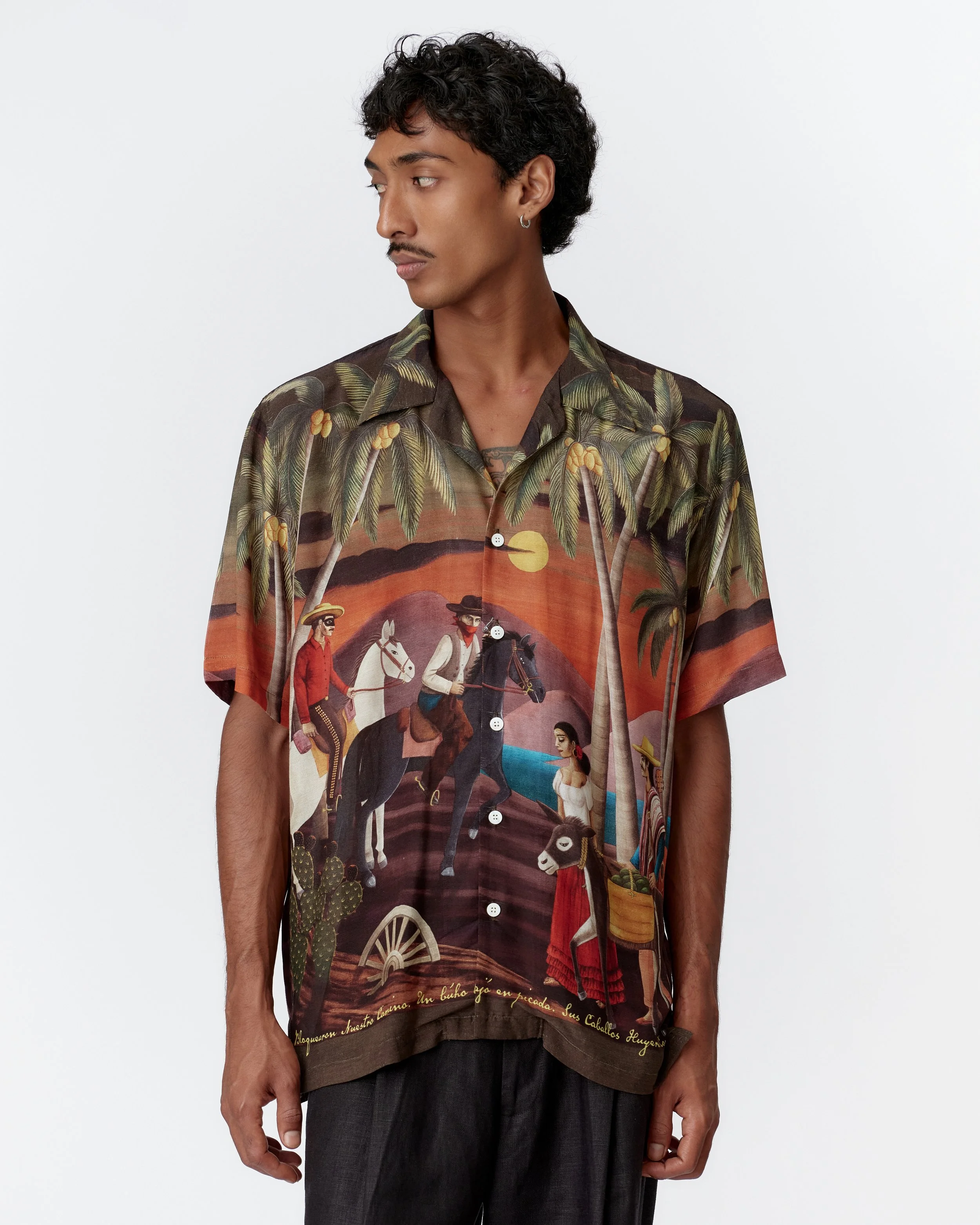 Close-up of camp collar and mother of pearl buttons on bottle green silk rayon shirt