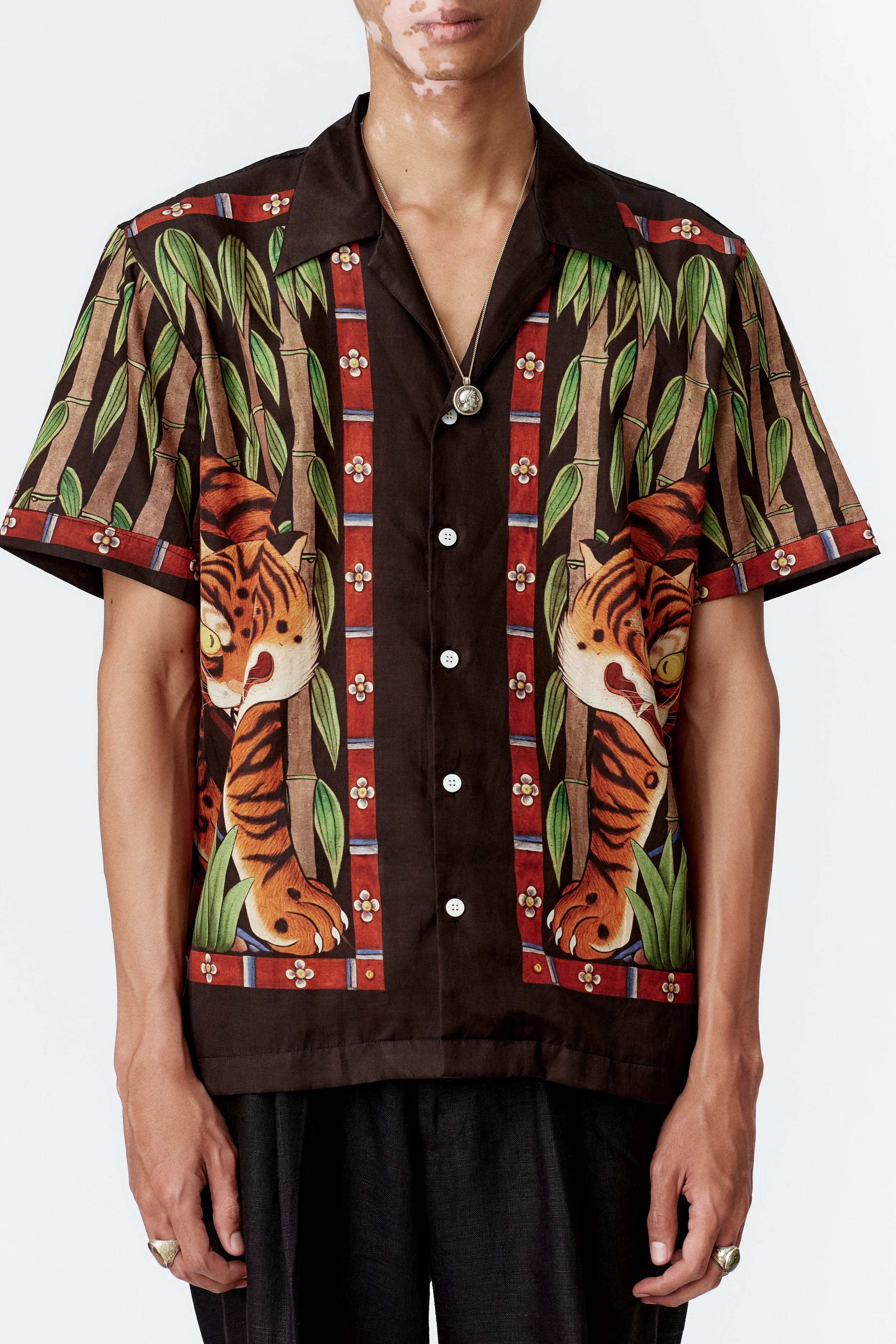 Chest detail showing ornate framed tiger print on black silk cotton fabric