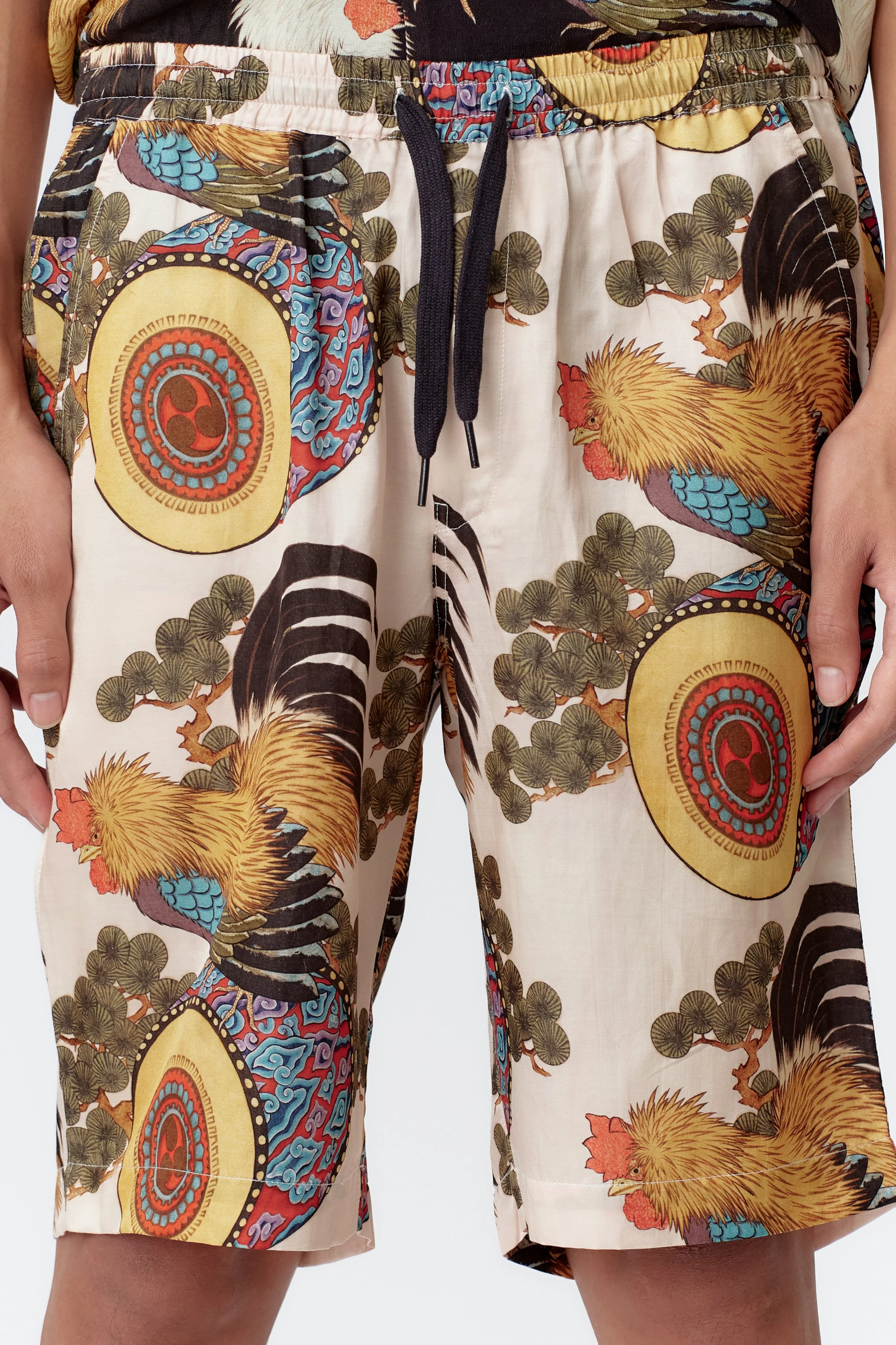 Close-up of Rooster Drum Board Shorts painting on cream silk cotton