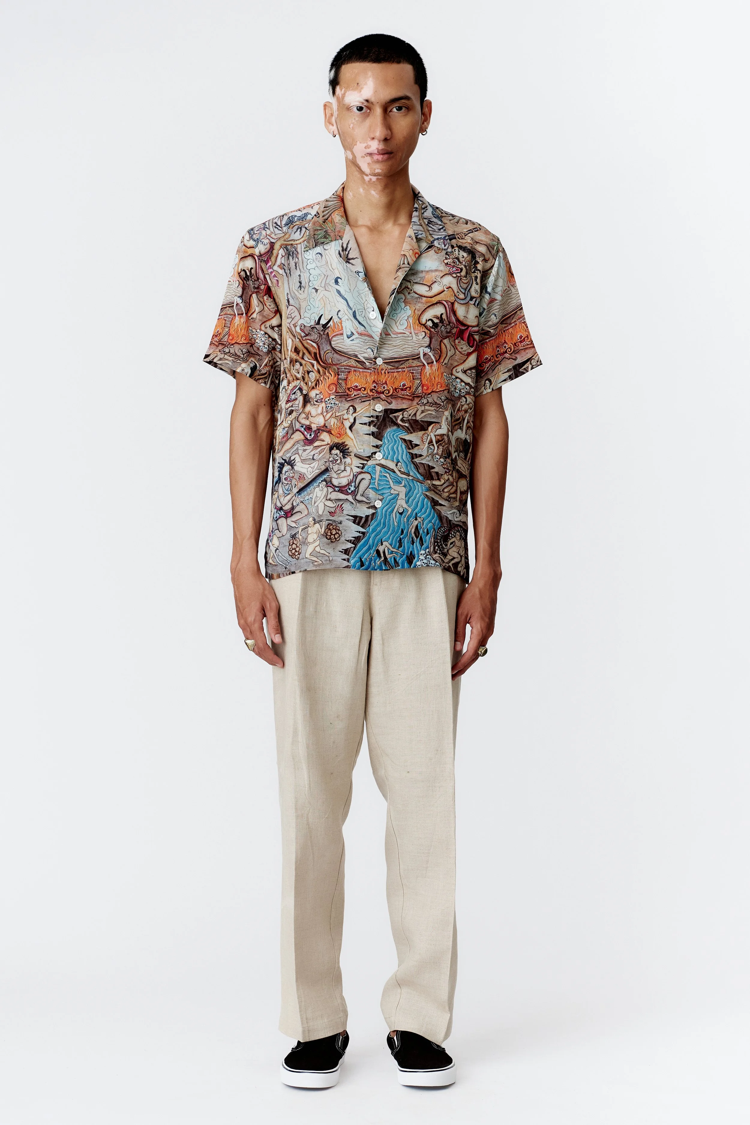 Full-length model image wearing Atma Penangsaran silk crepe short sleeve shirt showing straight hem and fluid drape.
