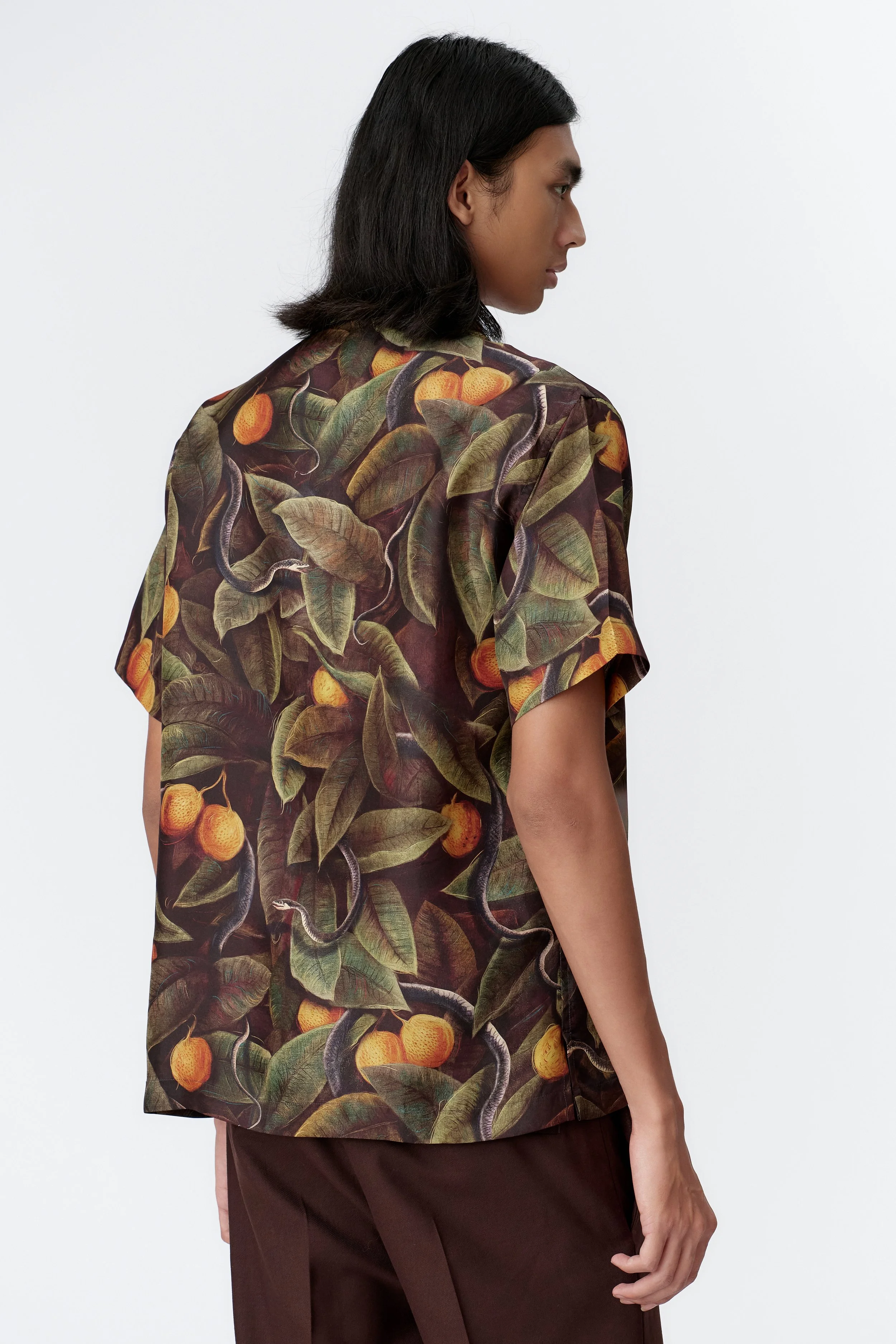 Back view of SNAKER limited edition silk satin short sleeve shirt in complementary green tones