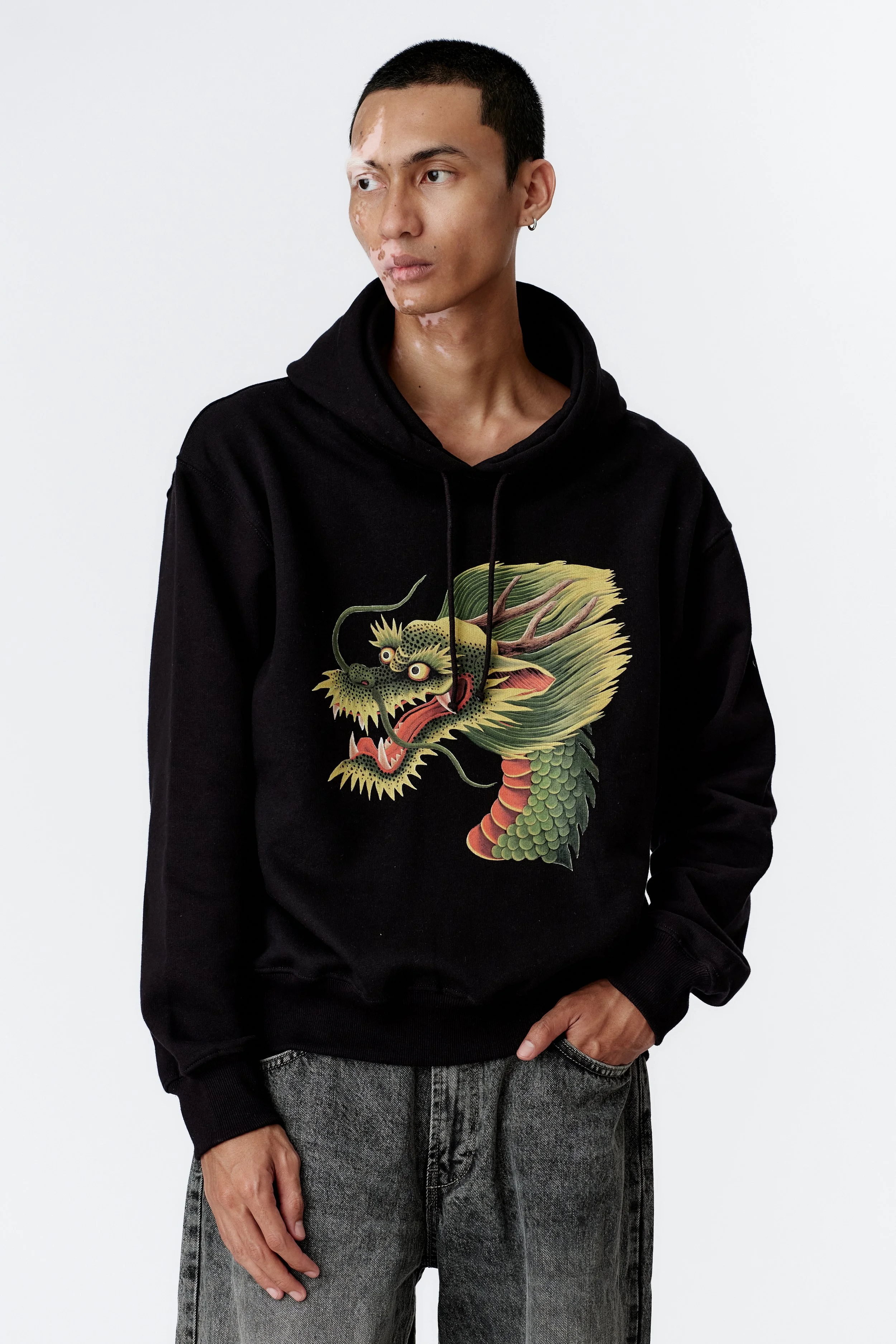 Close-up of dragon artwork on front of black heavyweight organic cotton hoodie