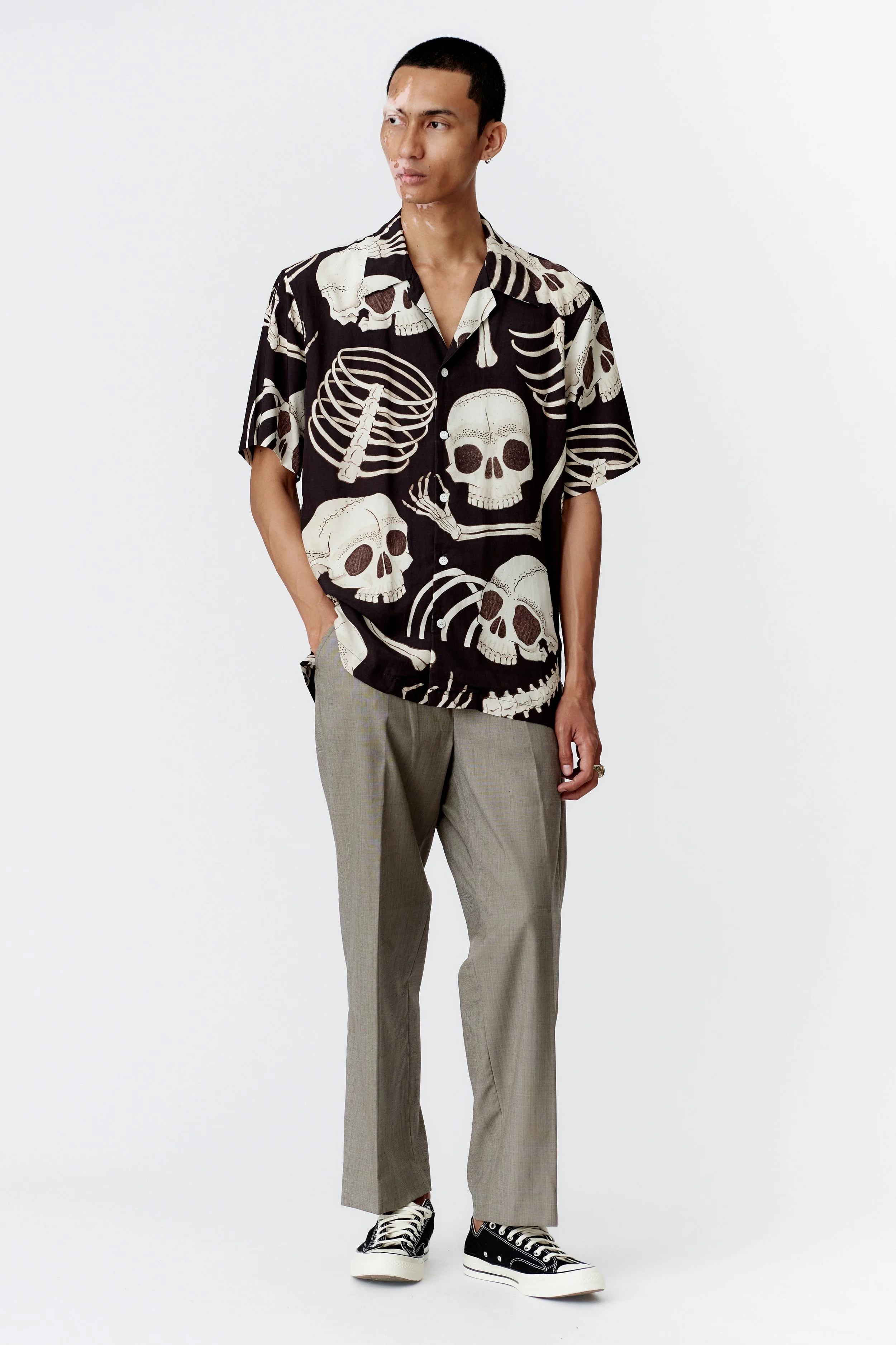 Full body view of model styling Skeleton black modal shirt with tailored trouser