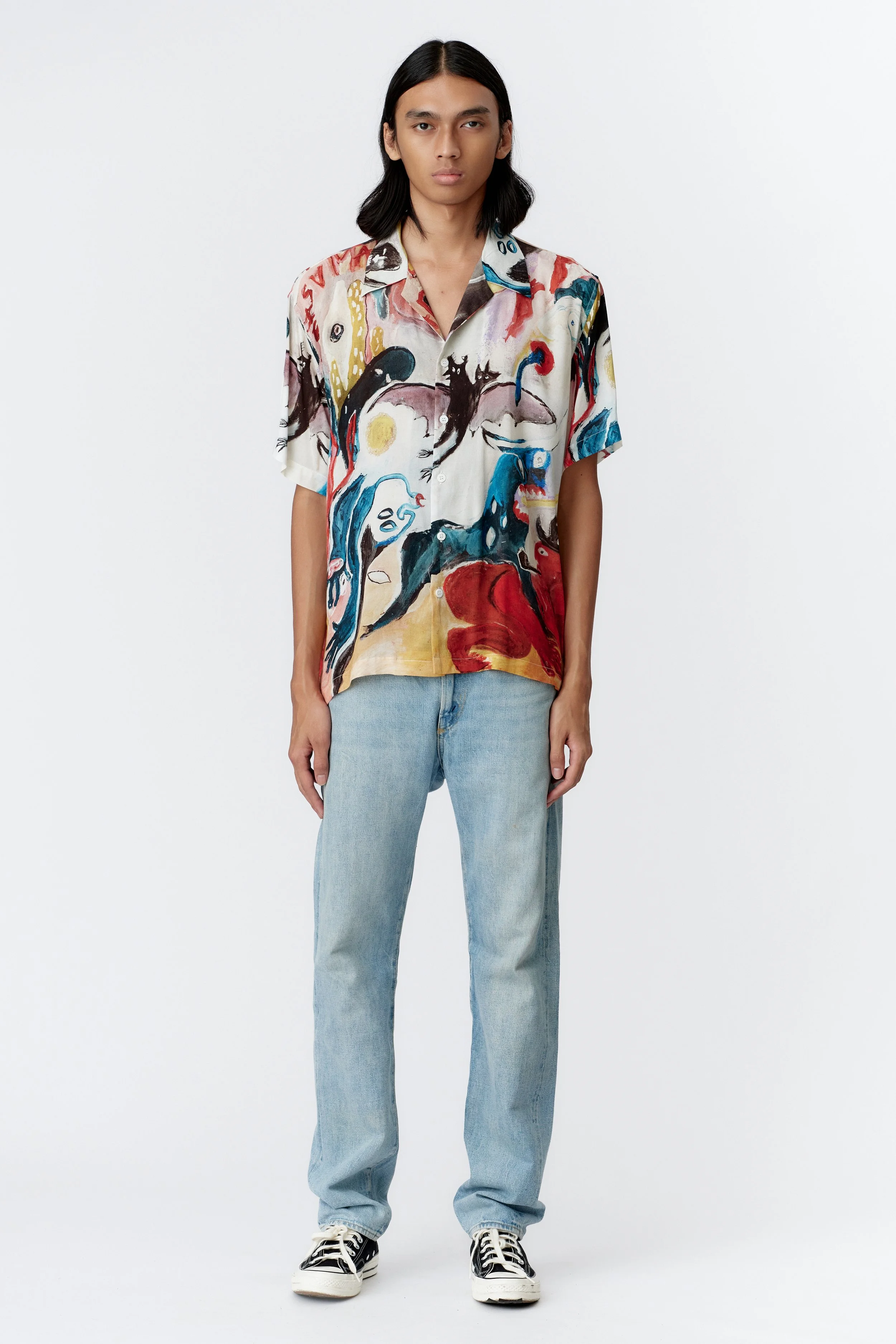 Full view of MAD AS HELL shirt showcasing flame-spewing blue demon dog and surreal melting faces