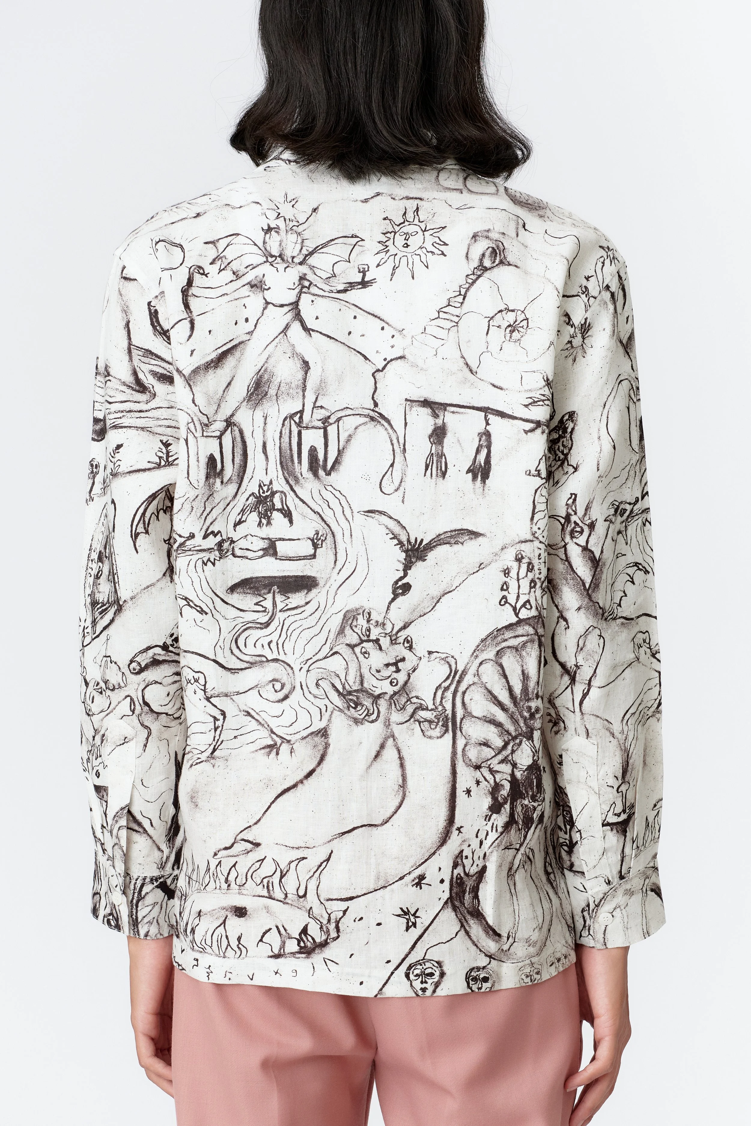 Rear close-up of black-and-white ALCHEMY linen long sleeve shirt illustrating intricate sketchwork and symbolic elements