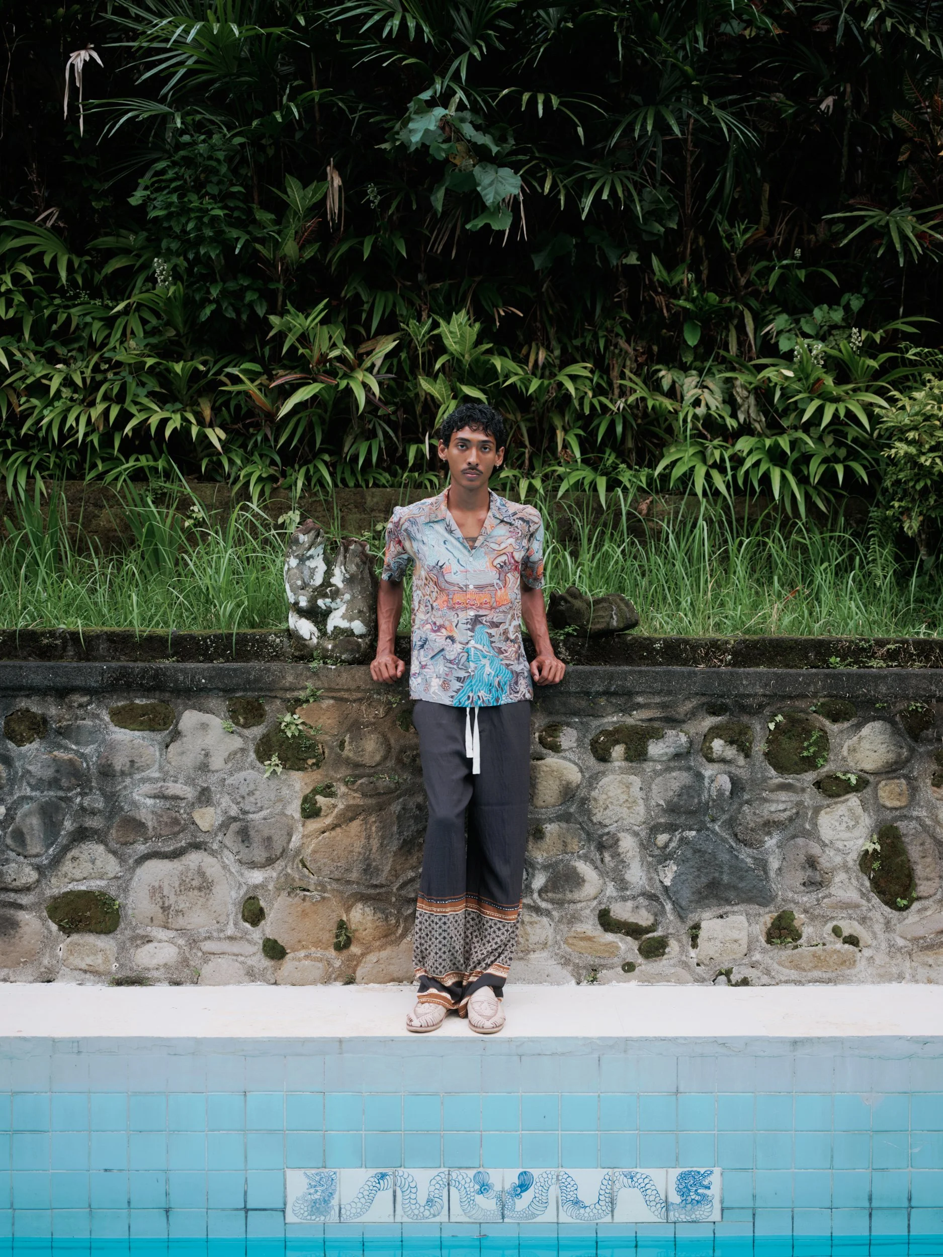 model poolside bali wearing endless joy shirt by deknoo