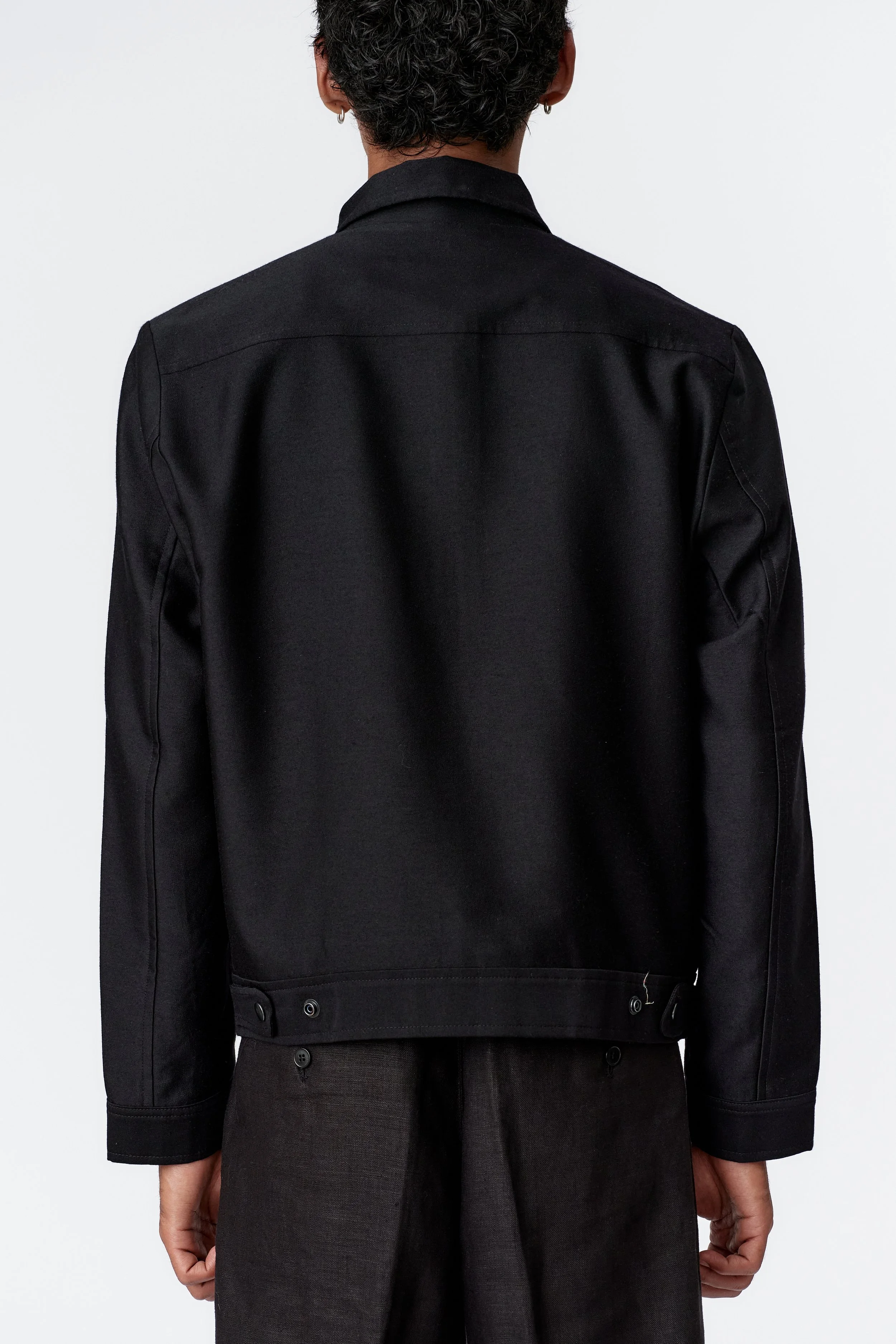 Back view of blouson jacket in solid black with sleeves in matching black