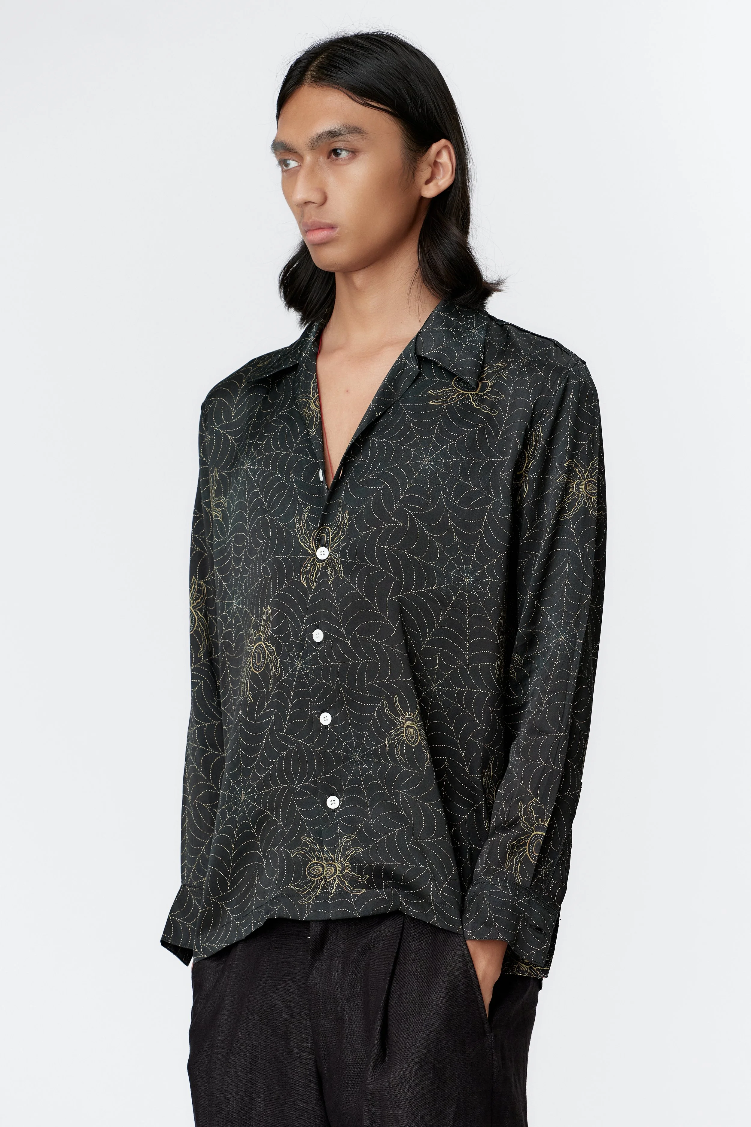 side view spider web artwork in gold on indigo silk satin fabric long sleeve.