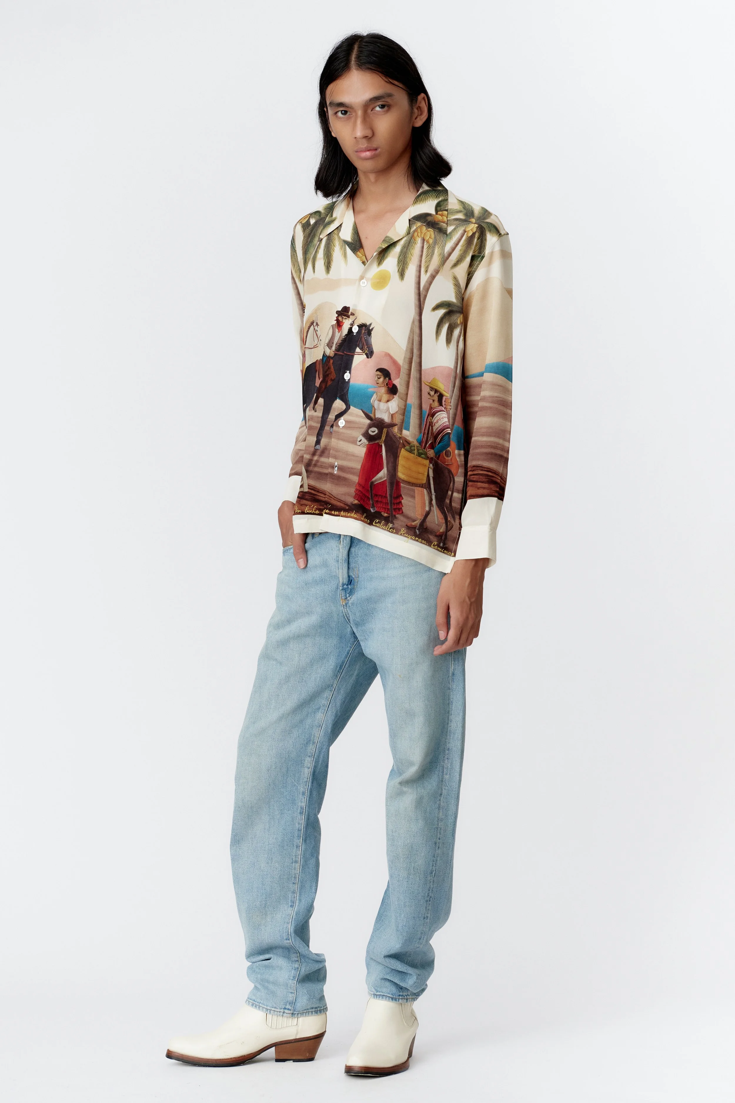Model wearing Bandito Off White 100% silk crepe long sleeve shirt, full front view showcasing surreal desert standoff artwork and camp collar.