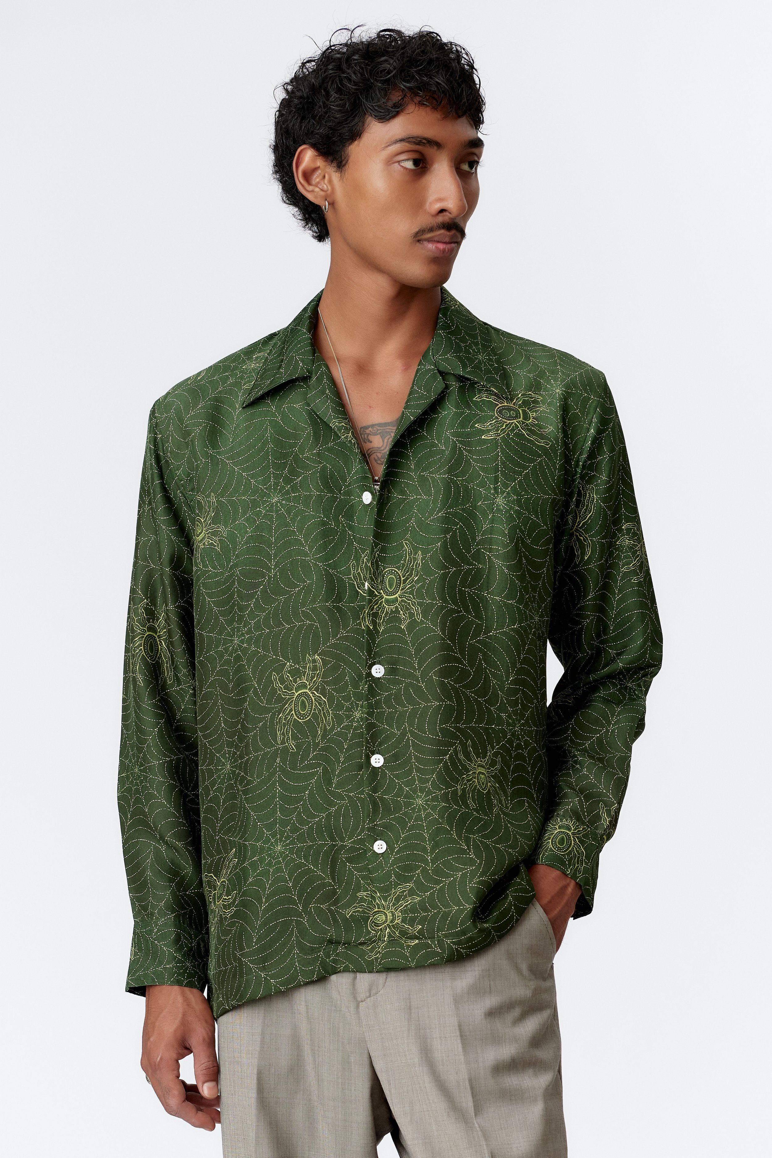 Angled front view of Spiderweb green 60% silk 40% cotton shirt with mother of pearl buttons