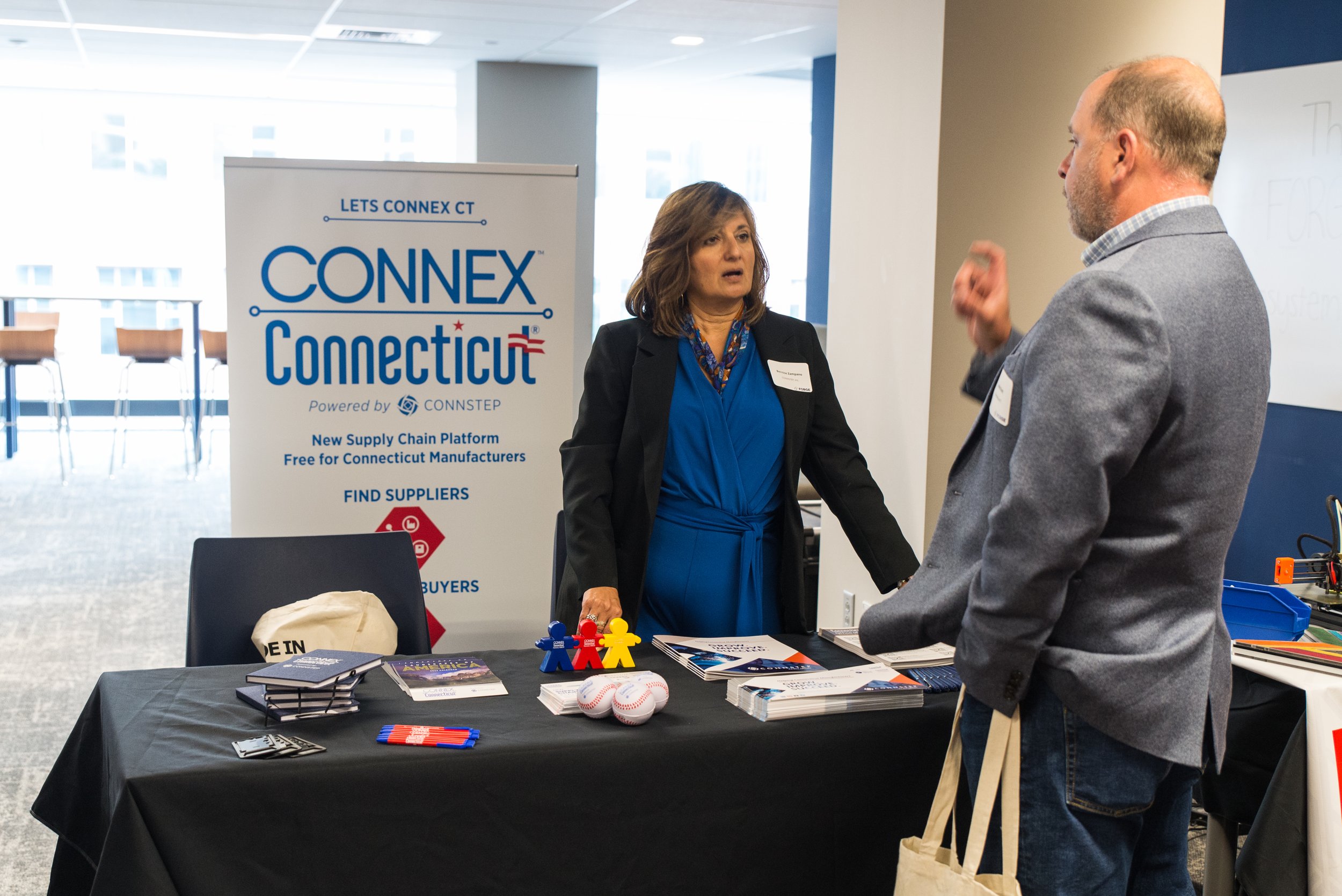  Bernice Zampano tells an attendee about CONNEX Connecticut  