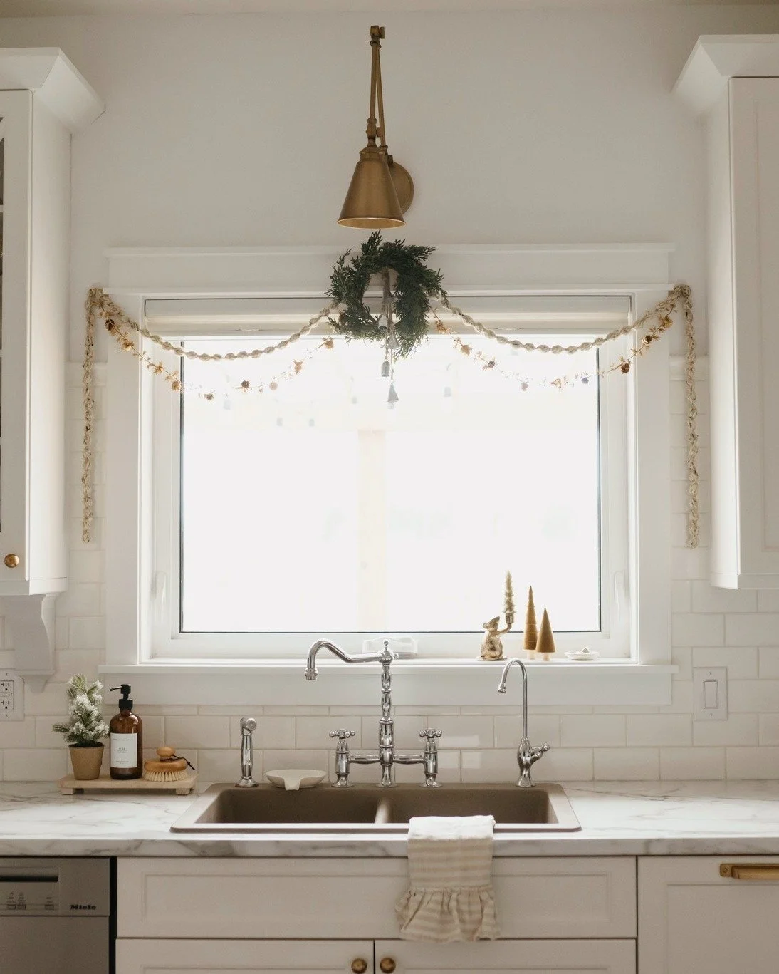 What I love about Christmas decorations are that they are so versatile -every year you can switch up what you're putting where. Take wreaths for example; hang them on the door, in the window, on your wall with artwork, leaning on a shelf behind other