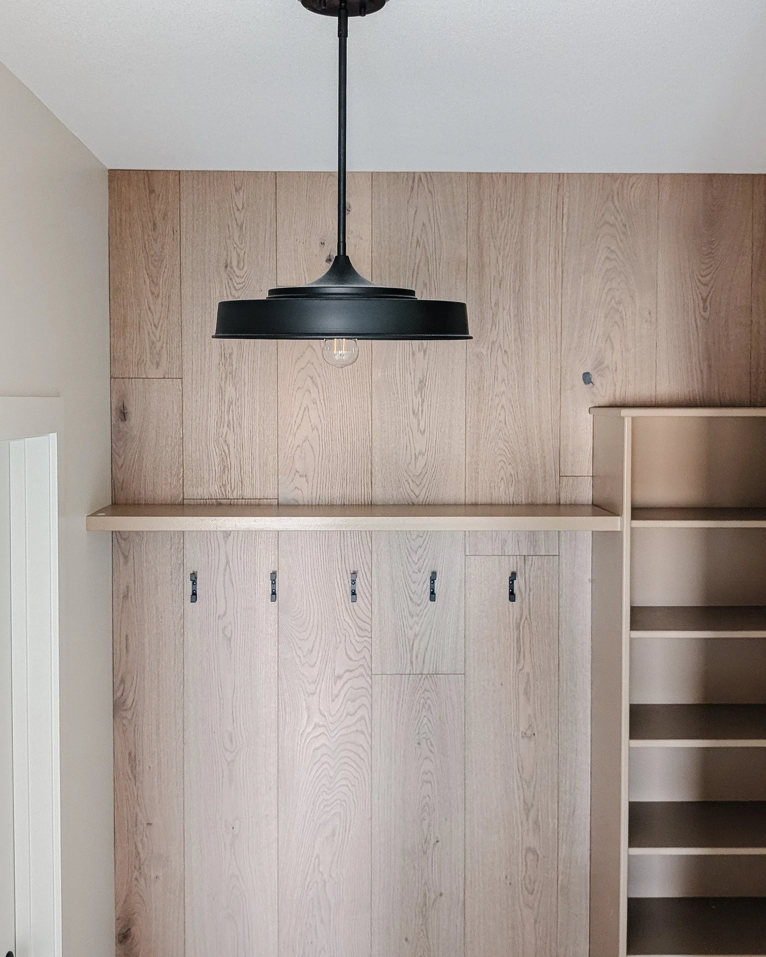 Working with a tight budget and the desire to make our Mocha Bungalows look NOT builder grade has been a fun challenge. Here's a peek at the mudroom where we created a feature wall using hardwood to warm up the space.
The beauty of real wood is unbea