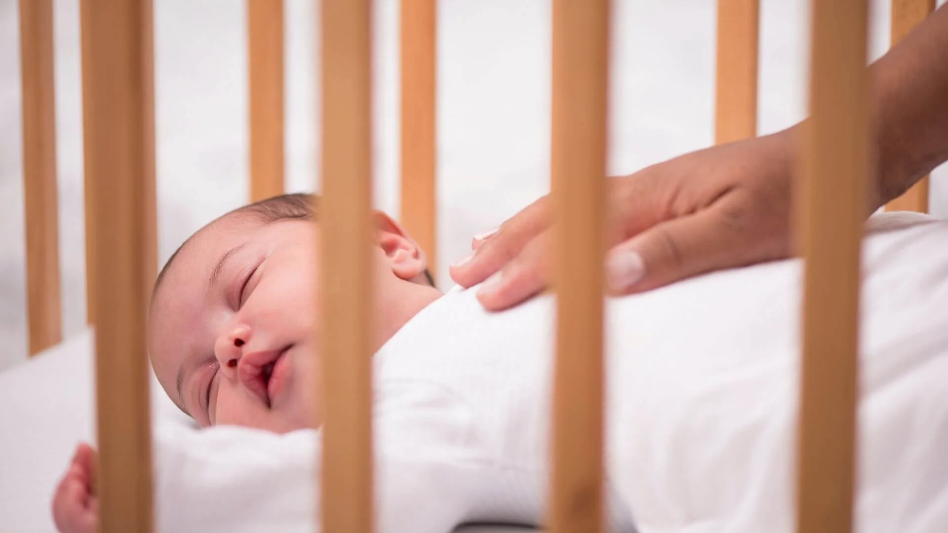 newborn baby sleeping in a crib
