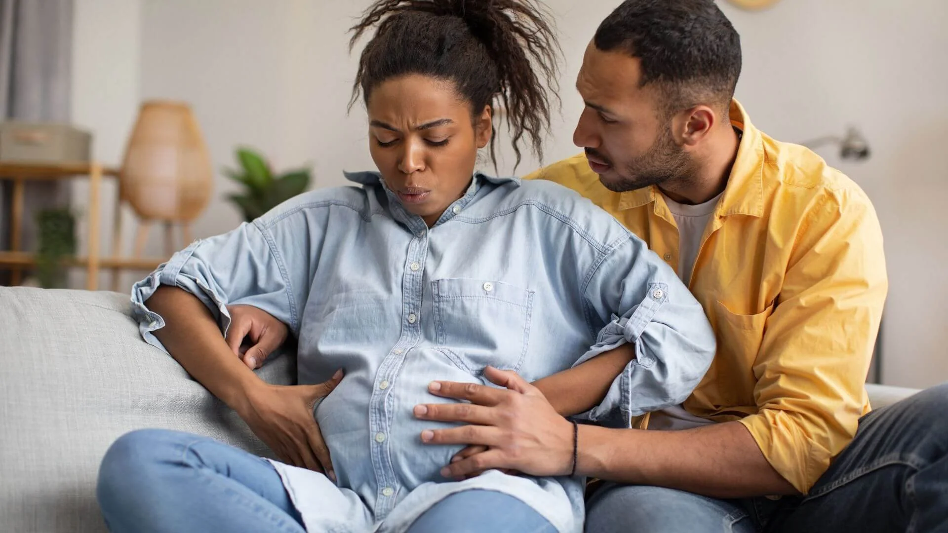 a partner helping their wife with birth contractions