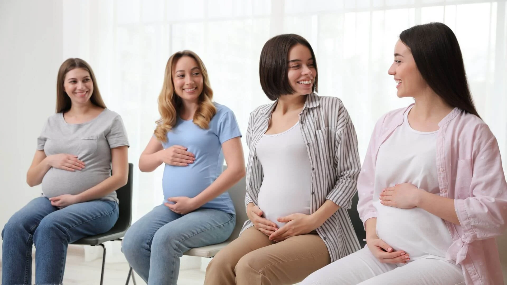 woman sitting together and smiling for a birth class