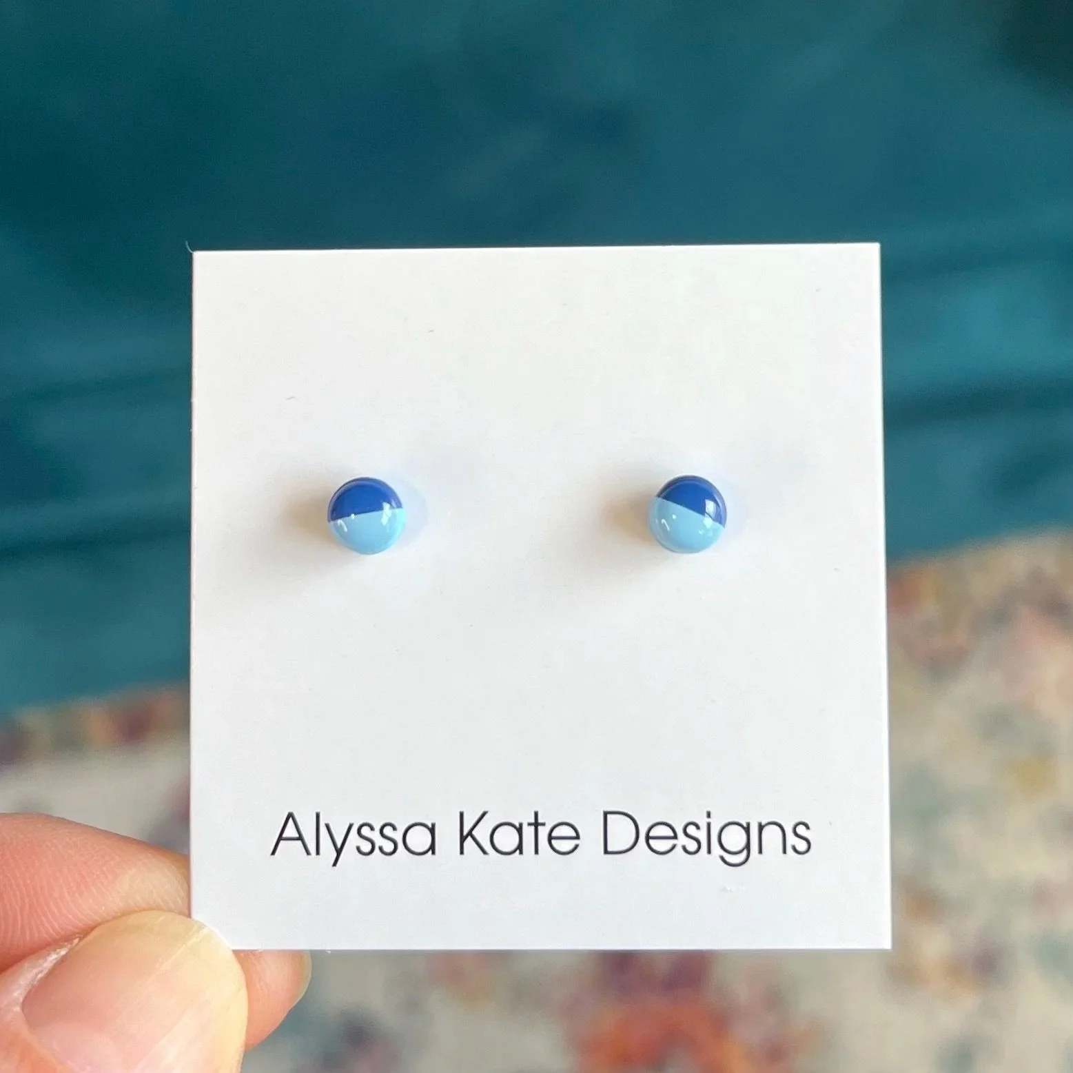 Light blue and navy handmade polymer clay Game Day stud earrings in a petite size