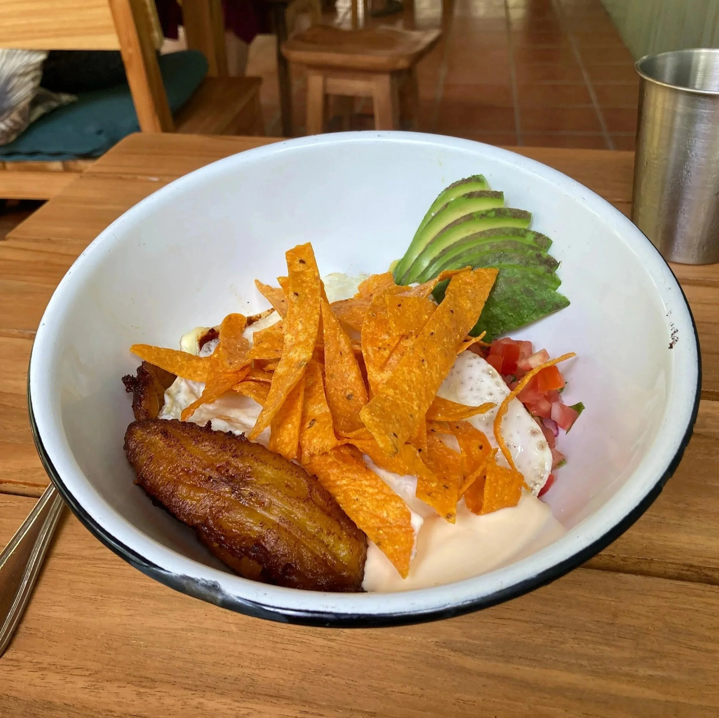 Gallo Pinto bowl with plantains, avocado, chips, eggs, and pico de gallo at La Ventanita in Nosara, Costa Rica.