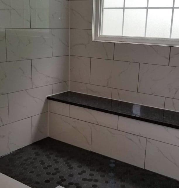 A spacious, fully wheelchair accessible shower, equipped with a no ledge, sloped floor entry and a marble slab bench. All completed by Classic Home Improvements. For any home renovation needs in Brantford and the surrounding area contact Classic Home