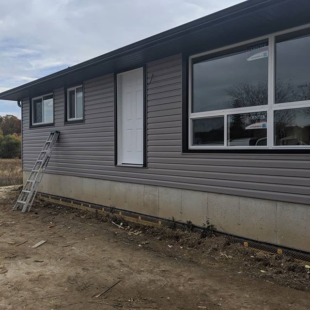 With new siding, soffit, eavestrough and windows, all this house is missing now is a way into the front door. For your next renovation project be sure to contact Classic Home Improvements at 519-752-6431