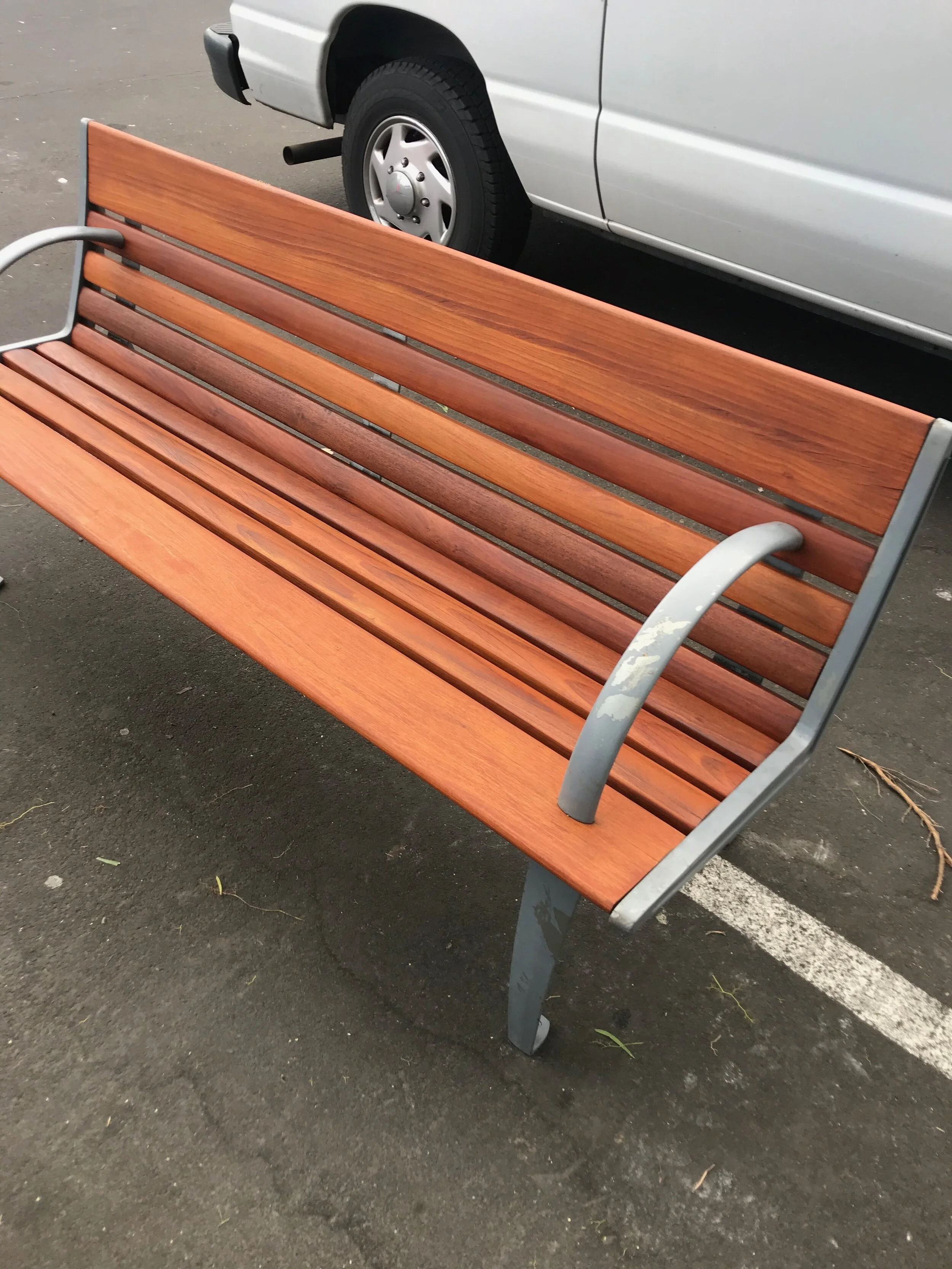 Beautiful Redwood bench in a outdoor shopping mall. If you maintain your wooden furniture it stays safe and sound for a long time.
