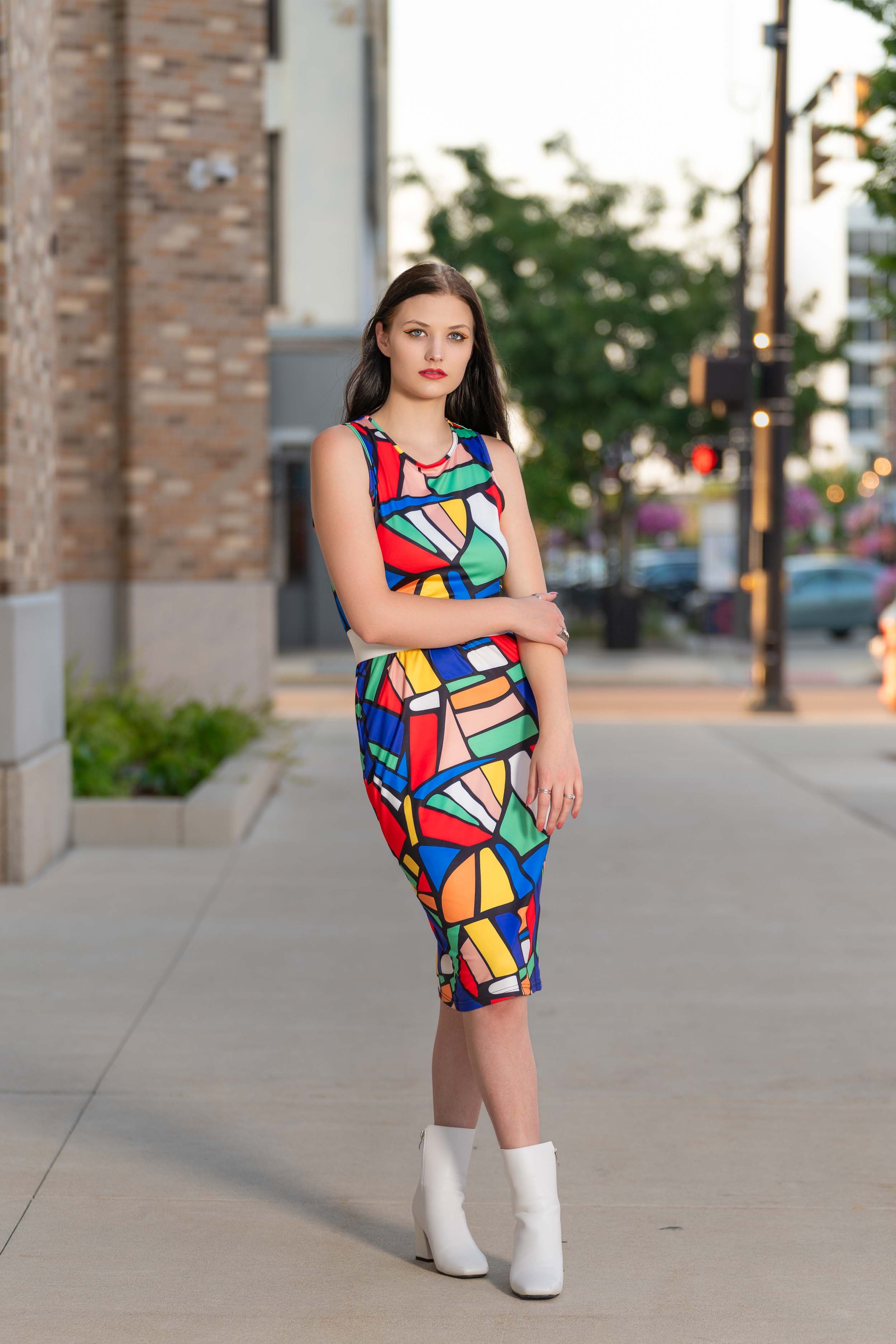 Model in a colorful geometric dress and white boots. Fashion and editorial photography in downtown South Bend, Indiana.