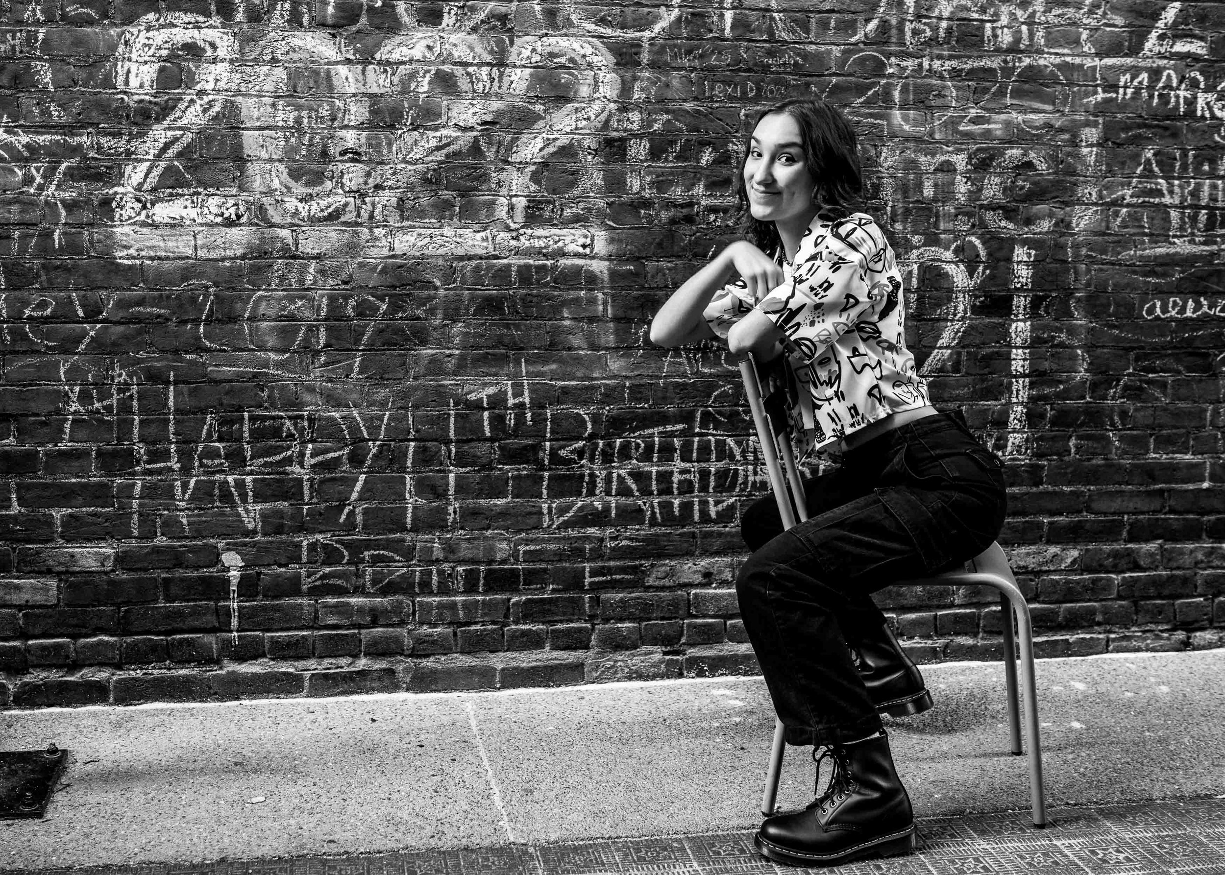 Black and white urban senior photo in Mishawaka at a graffiti wall by James Russell Photography.