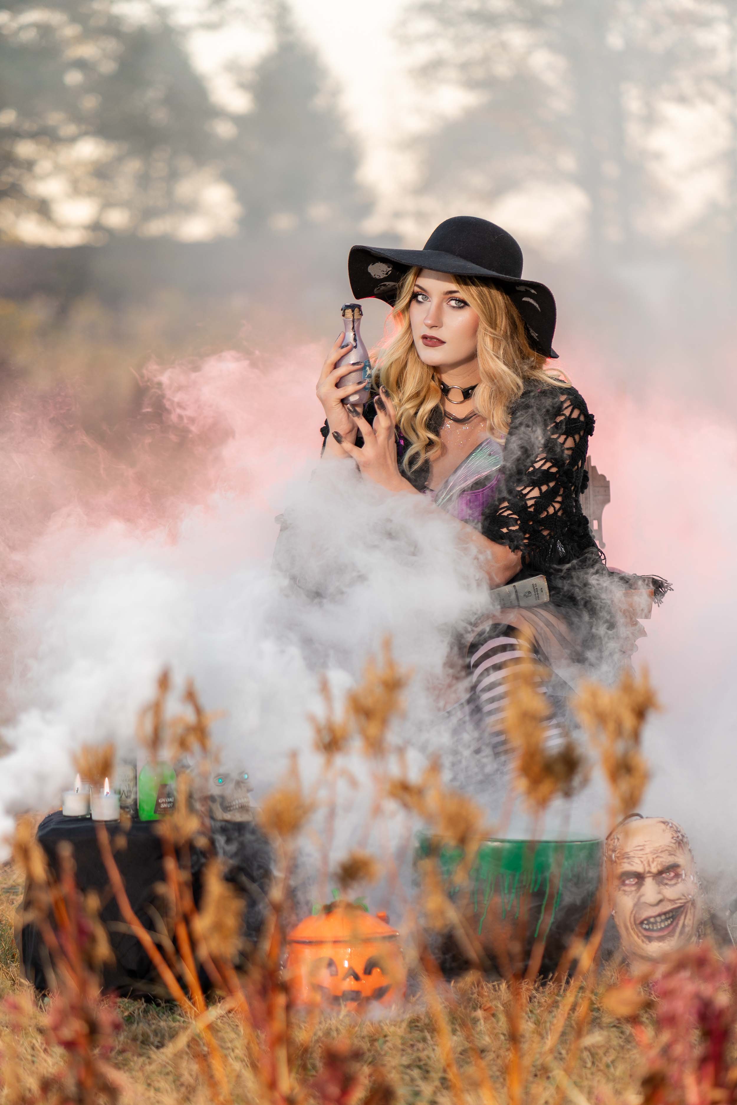 Creative Halloween themed portrait photography in South Bend, Indiana, featuring a witch and smoke effects.