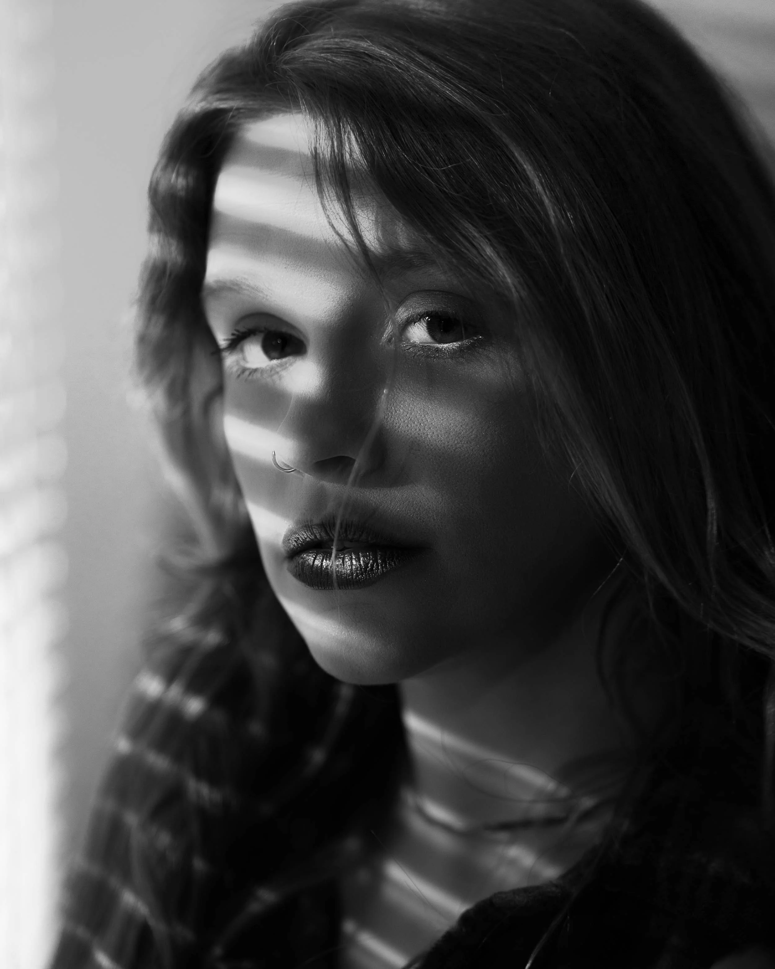 Dramatic black and white boudoir photography in Michiana featuring creative shadow lighting.