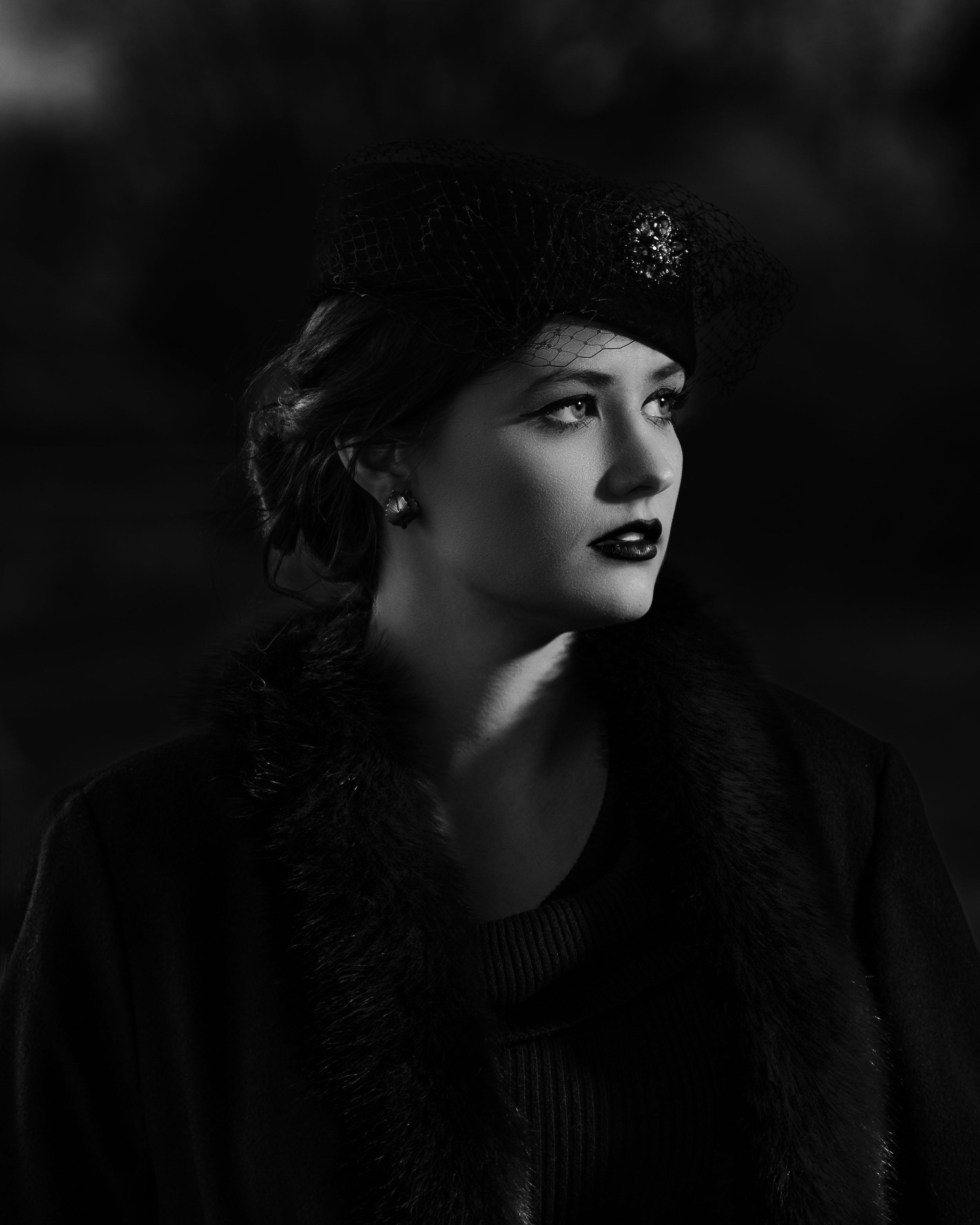 Dramatic black and white editorial portrait of a woman in a vintage hat and fur-trimmed coat, Northern Indiana.