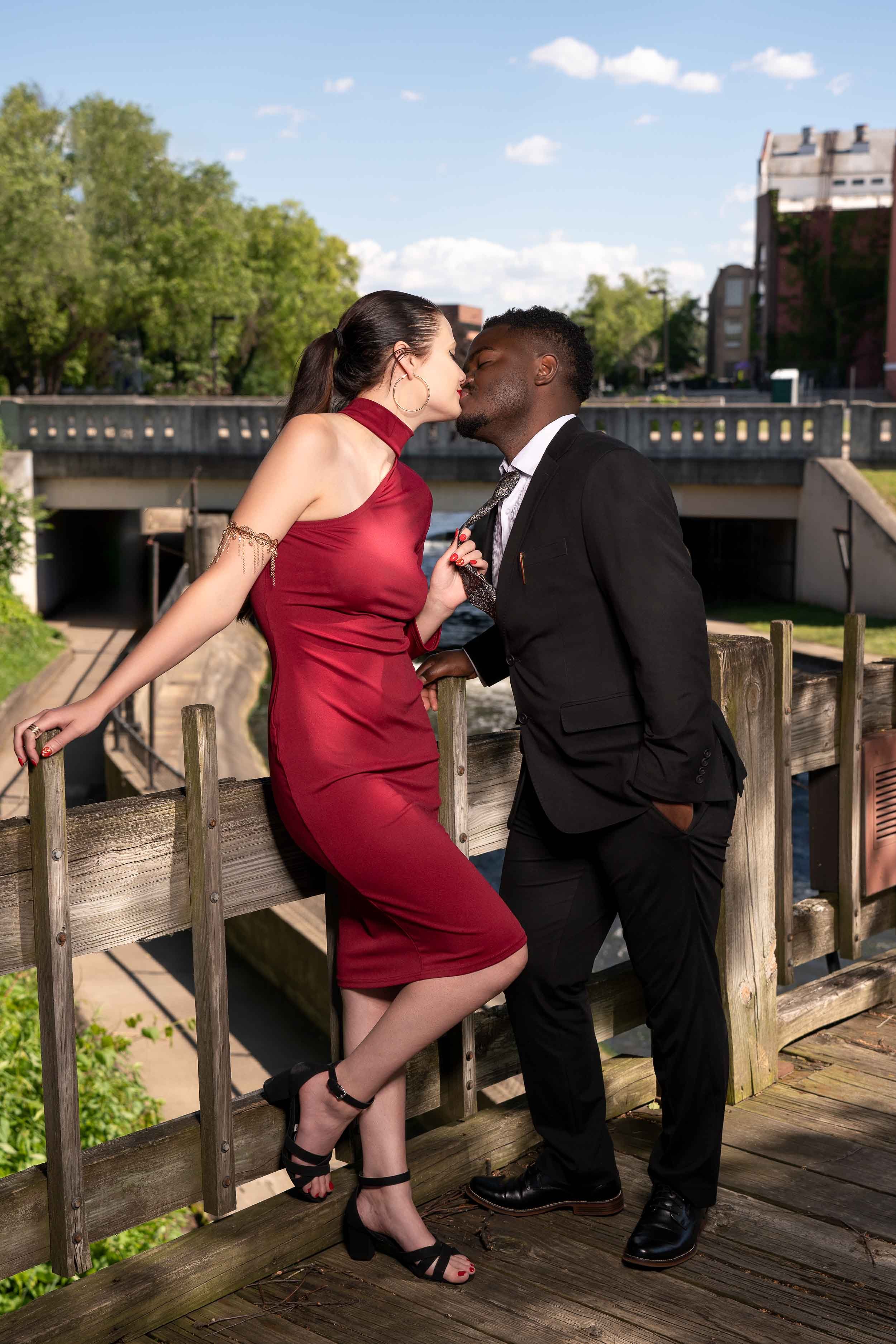 Romantic engagement couple portrait in downtown South Bend, Michiana, featuring an urban bridge background.