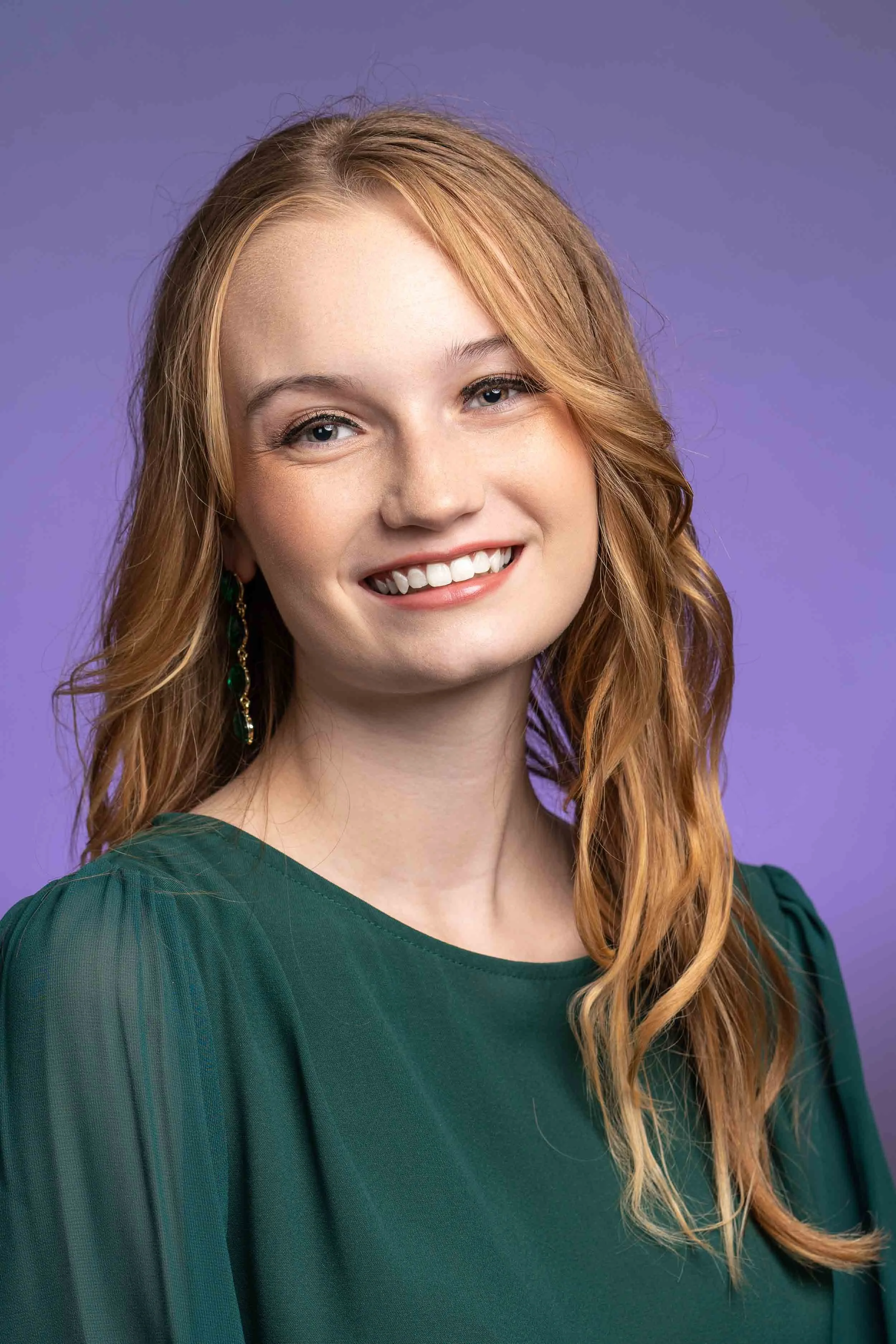 Professional studio headshot in South Bend featuring a woman in a green blouse, showcasing clean lighting for Northern Indiana business professionals.