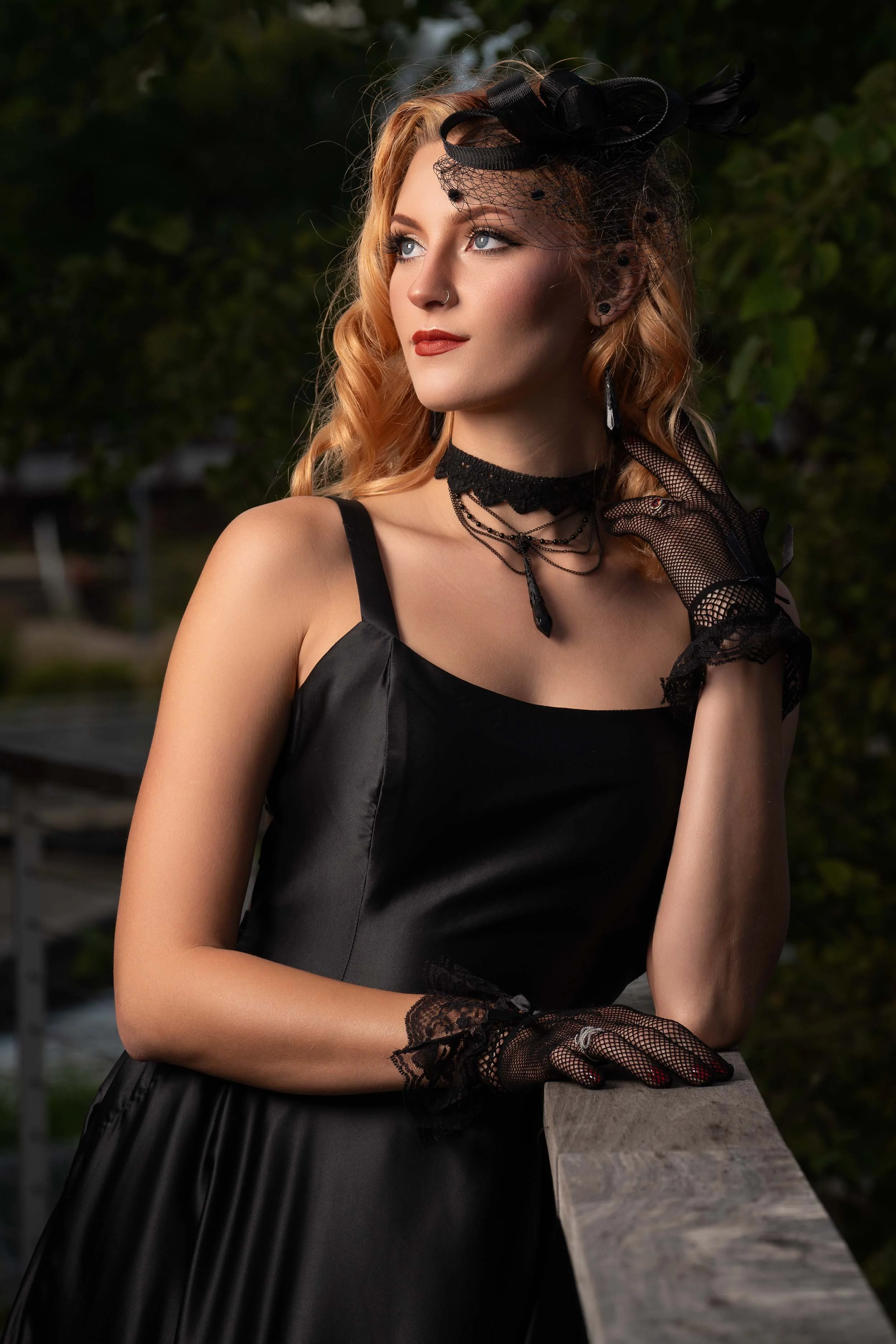 Gothic fashion editorial photography featuring a model in a black silk dress and lace gloves in Southern Michigan.