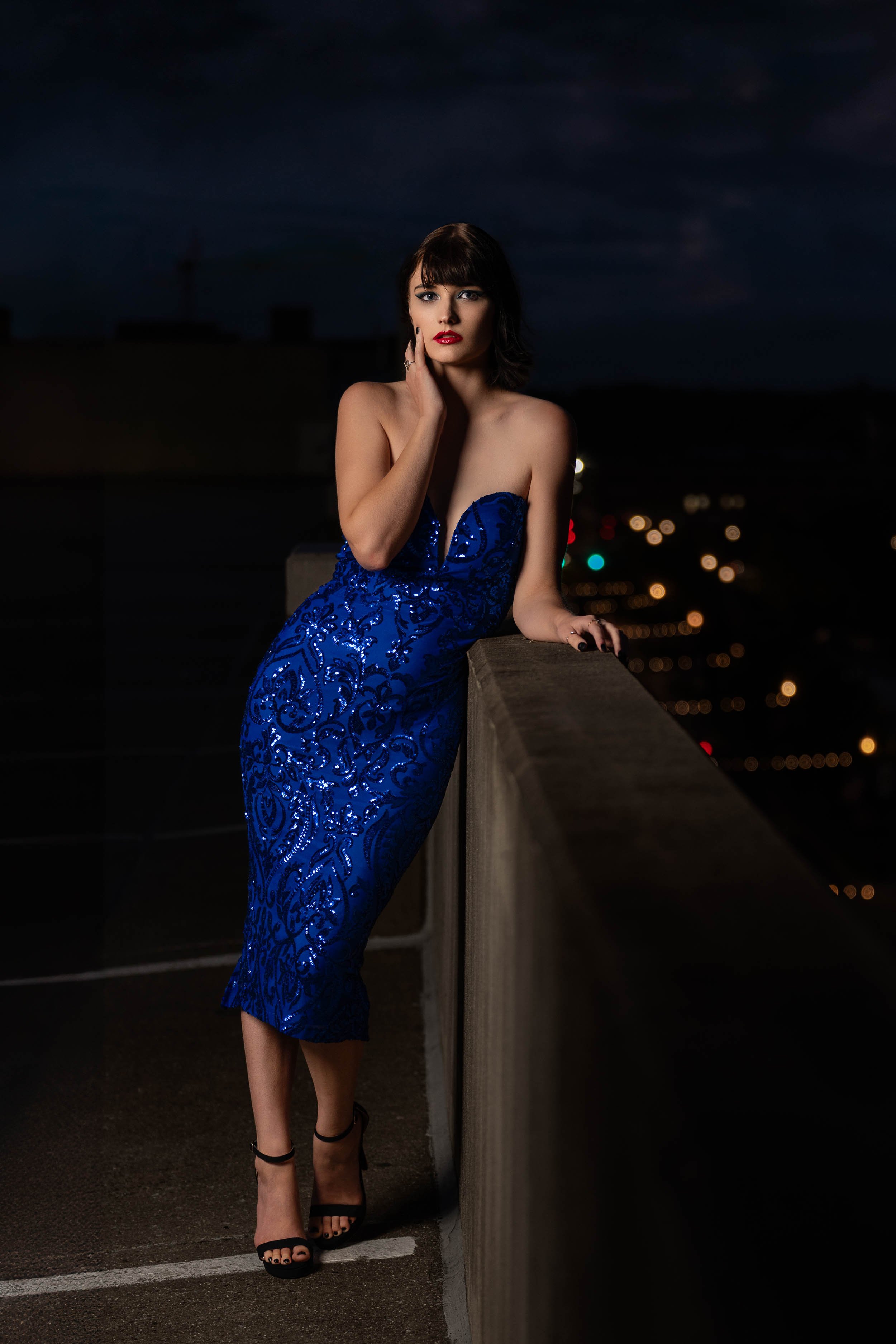 Portrait of a woman in a blue formal sequin dress on a rooftop at night in South Bend, Indiana.