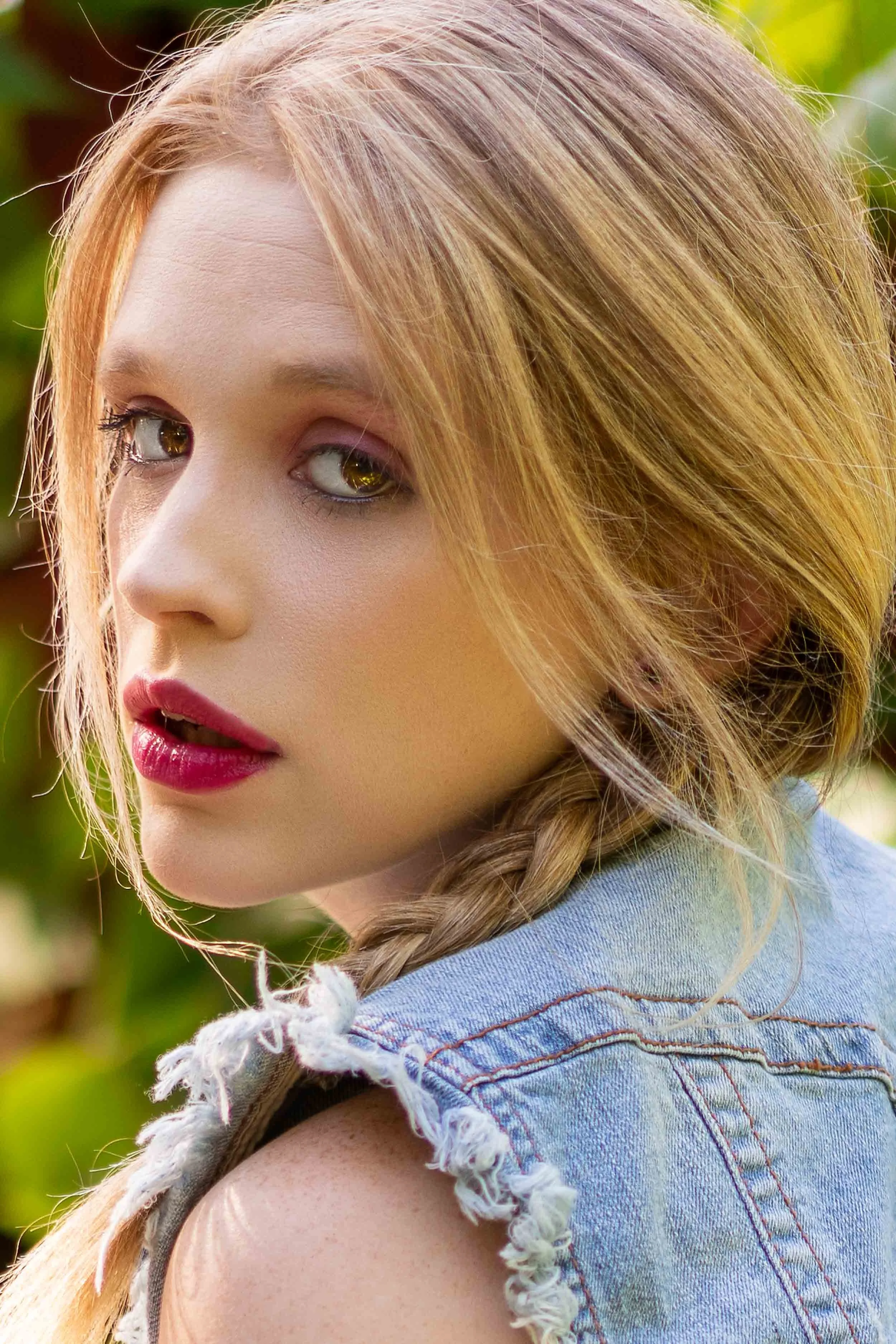 High-end editorial lifestyle portrait of a blonde woman in a denim vest, styled for a fashion shoot in Northern Indiana and Southern Michigan.
