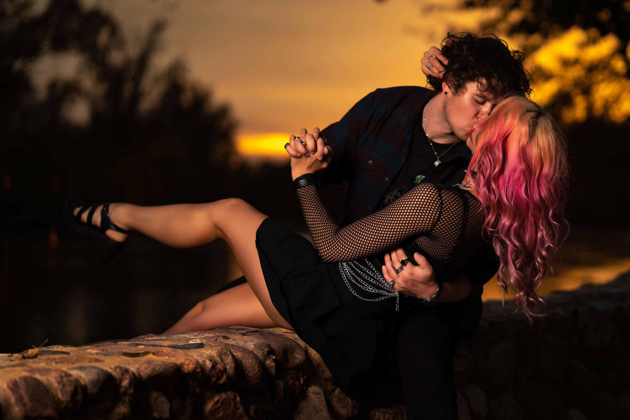 Sunset engagement session by a South Bend photographer featuring a romantic kiss in Northern Indiana.