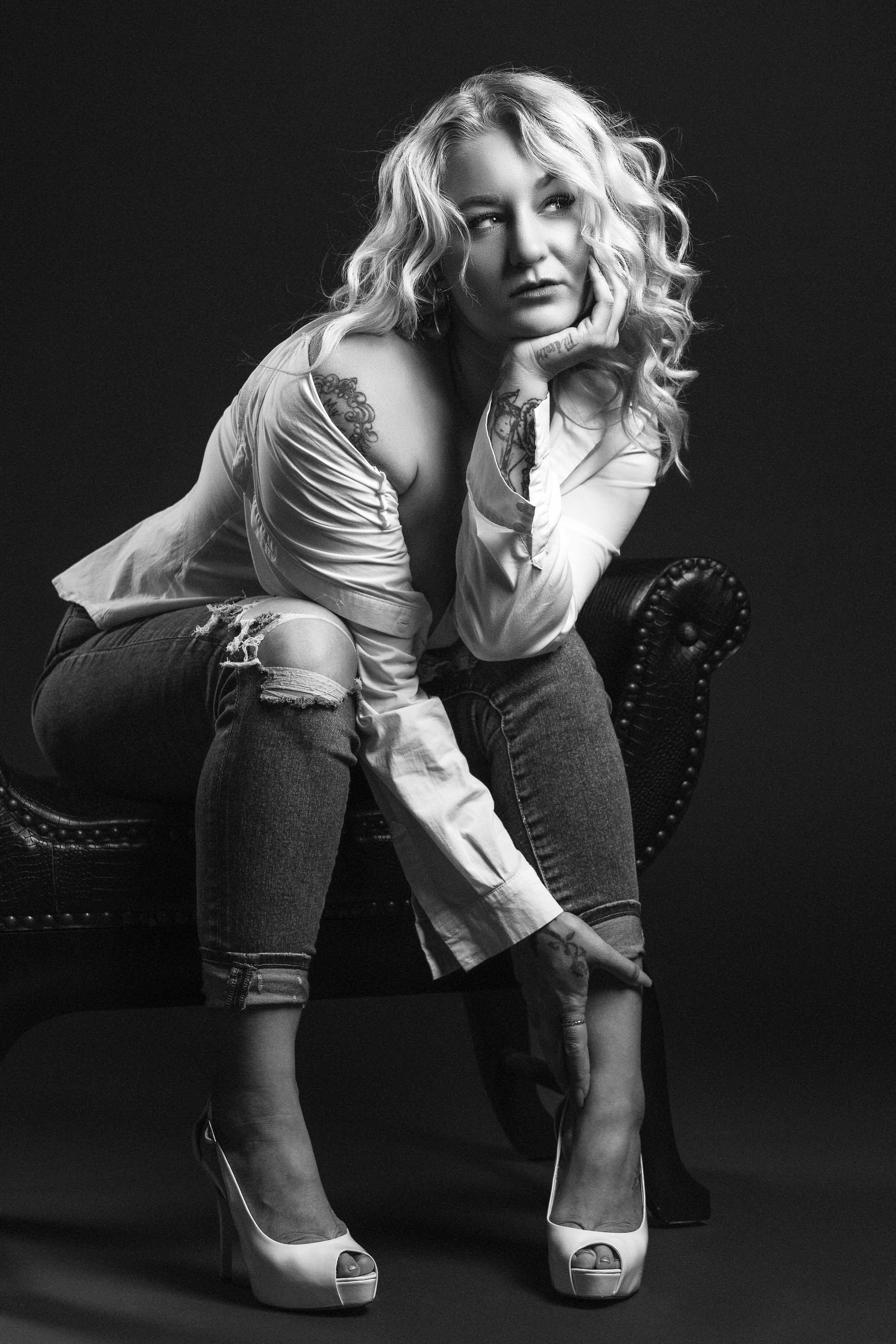 Black and white boudoir portrait of a woman on a chaise lounge. Professional studio photography serving Michiana and Southern Michigan.