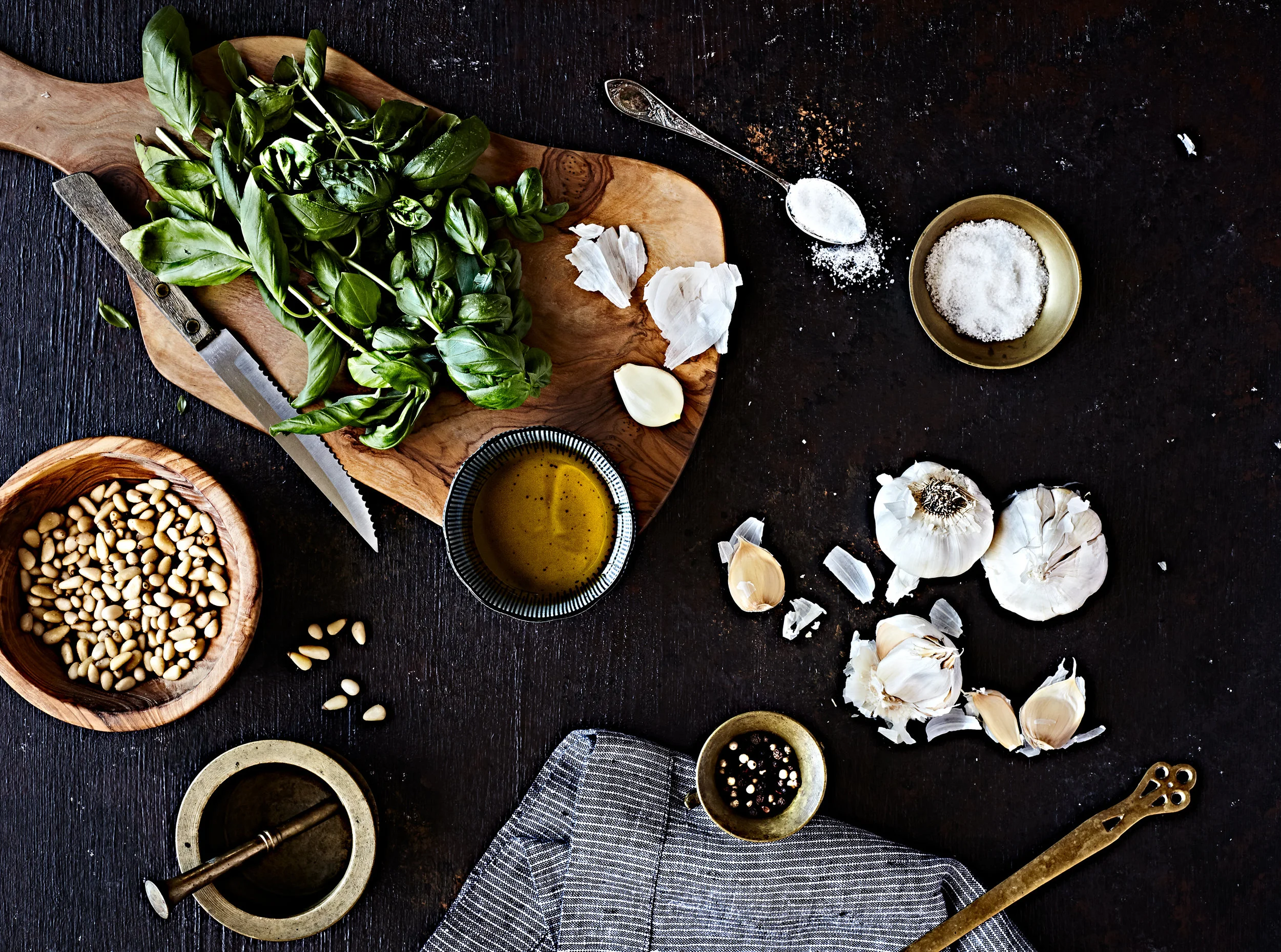 Ingredients for basil pesto on black tabletop