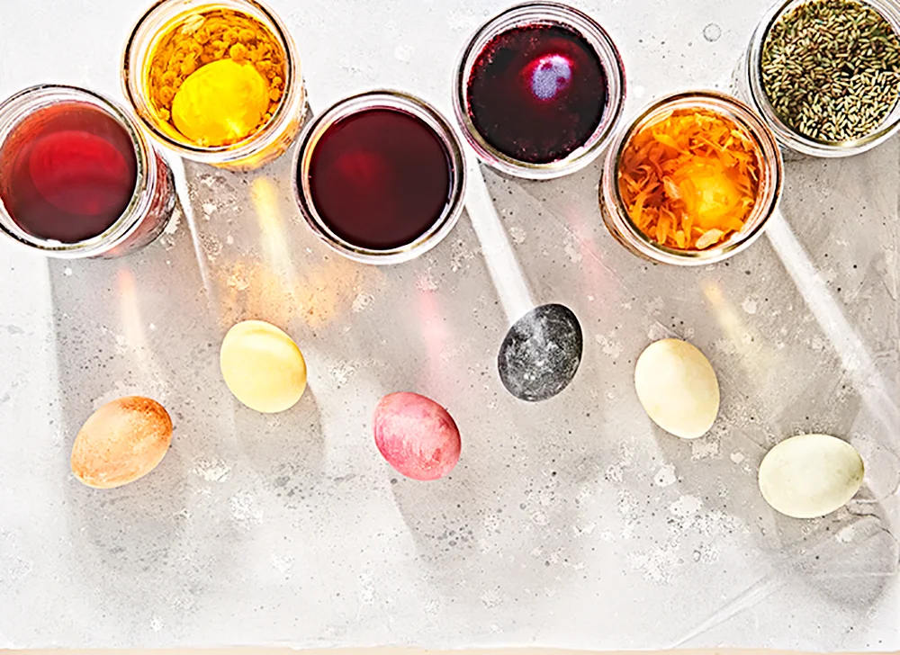 Tea dyed easter eggs in cups of dye