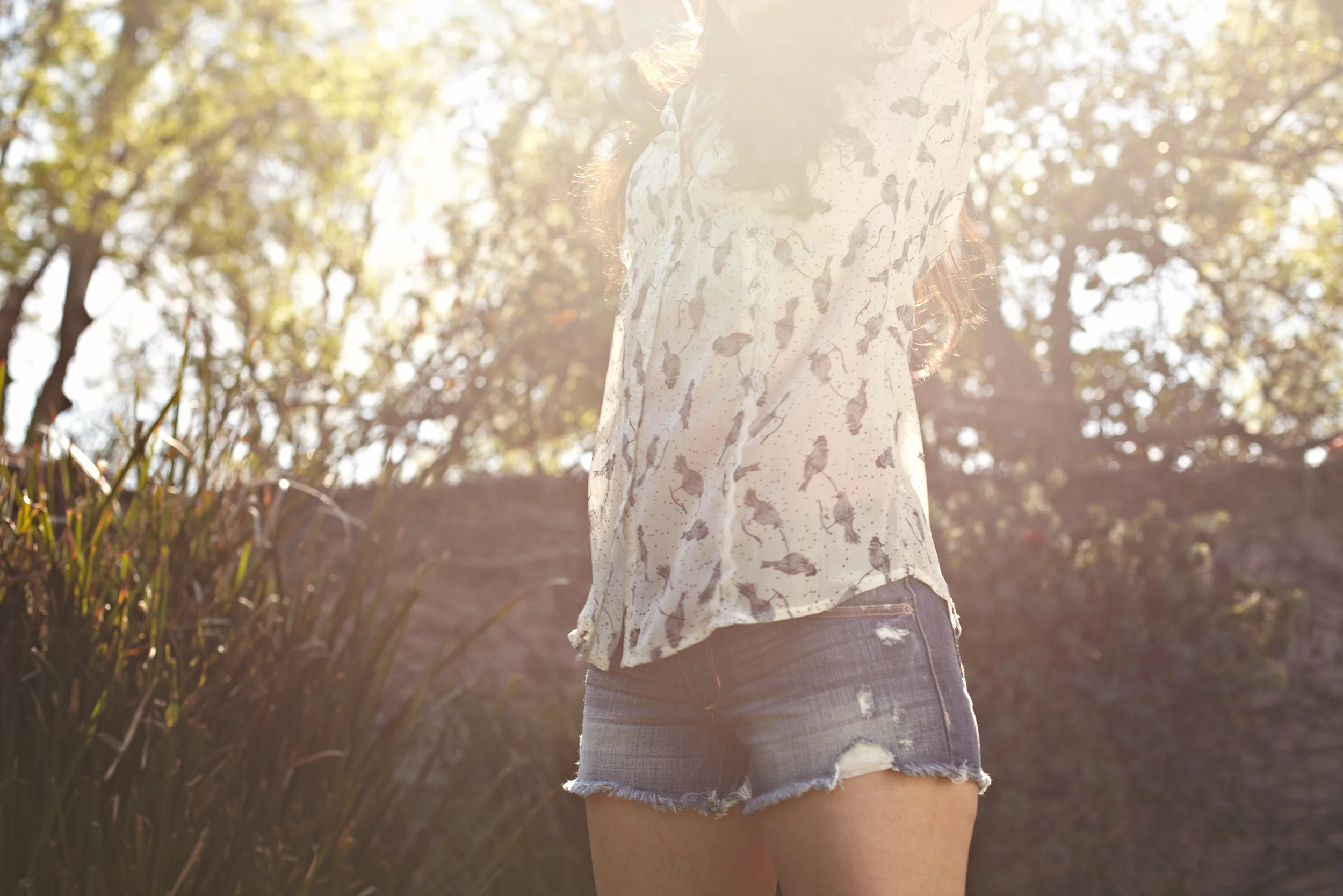 Young woman stretching in the sunshine