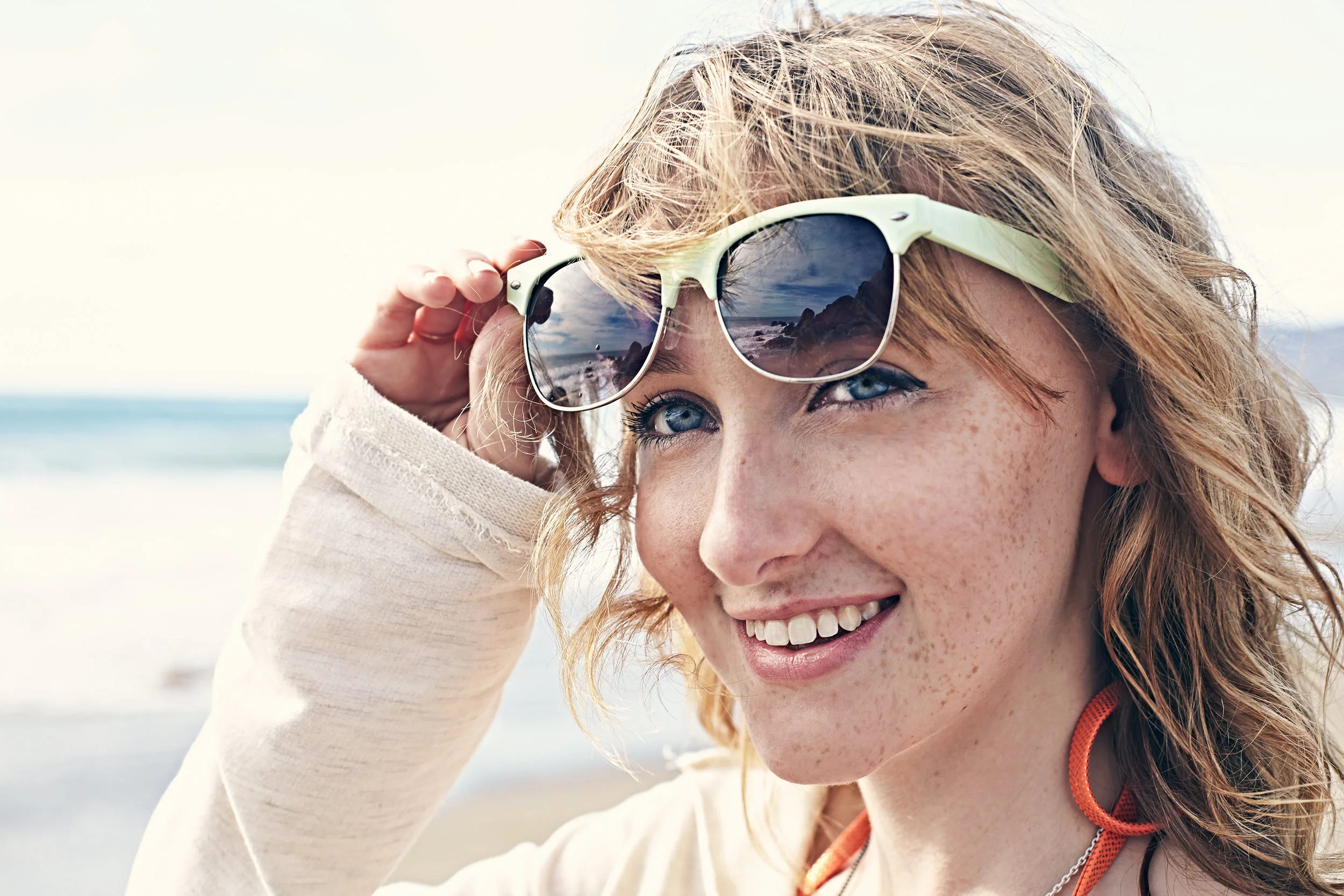Young woman in sunglasses on the beach