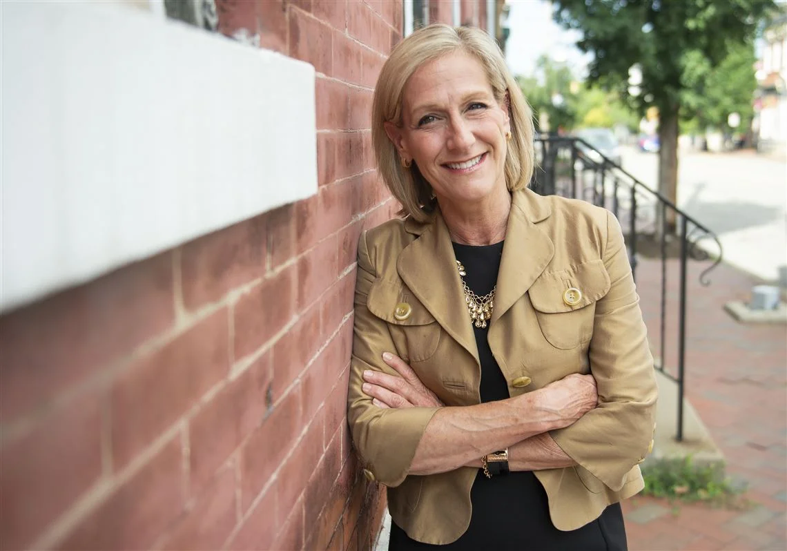 Photo of Lisa leaning on brick wall by Caitlin Lee of Pittsburgh Post-Gazette