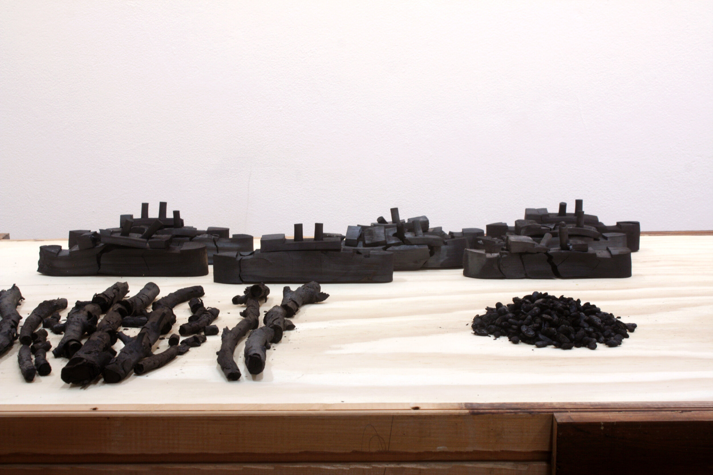    Carbon, atomic number 6   (detail) ,  2013  Material: carbonised objects and table of person/s unknown. 