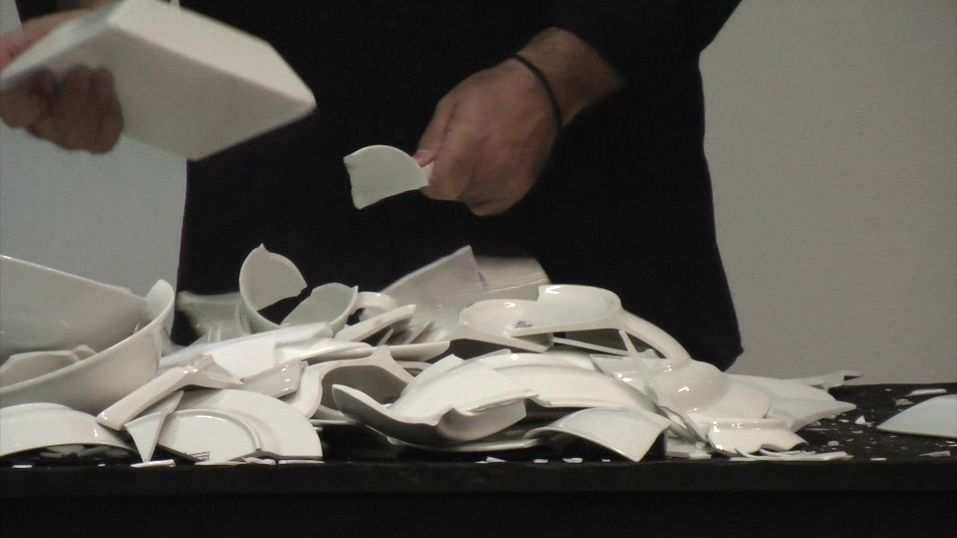    Breaking cups, bowls and plates once shared  , 2013, Still from video 