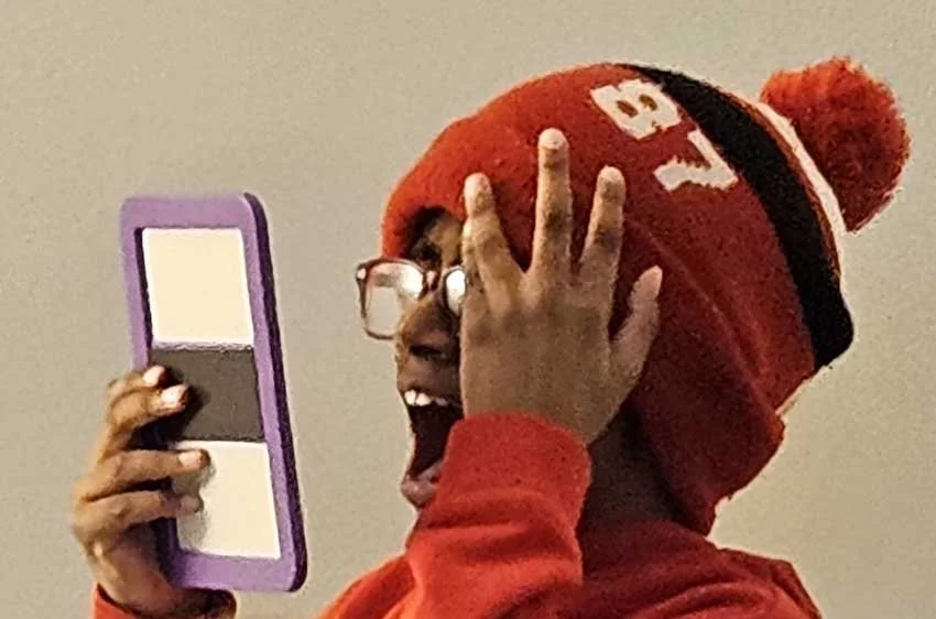 A student studies expressions in a mirror to make his art come to life in a new way at Cartoon Camp!