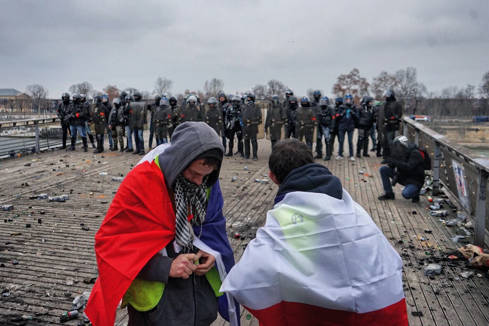  Standing right behind Gillette and Jones, across from a line of locked and loaded policemen, probably wasn’t the brightest thing I’ve ever done. Passerelle Léopold. 
