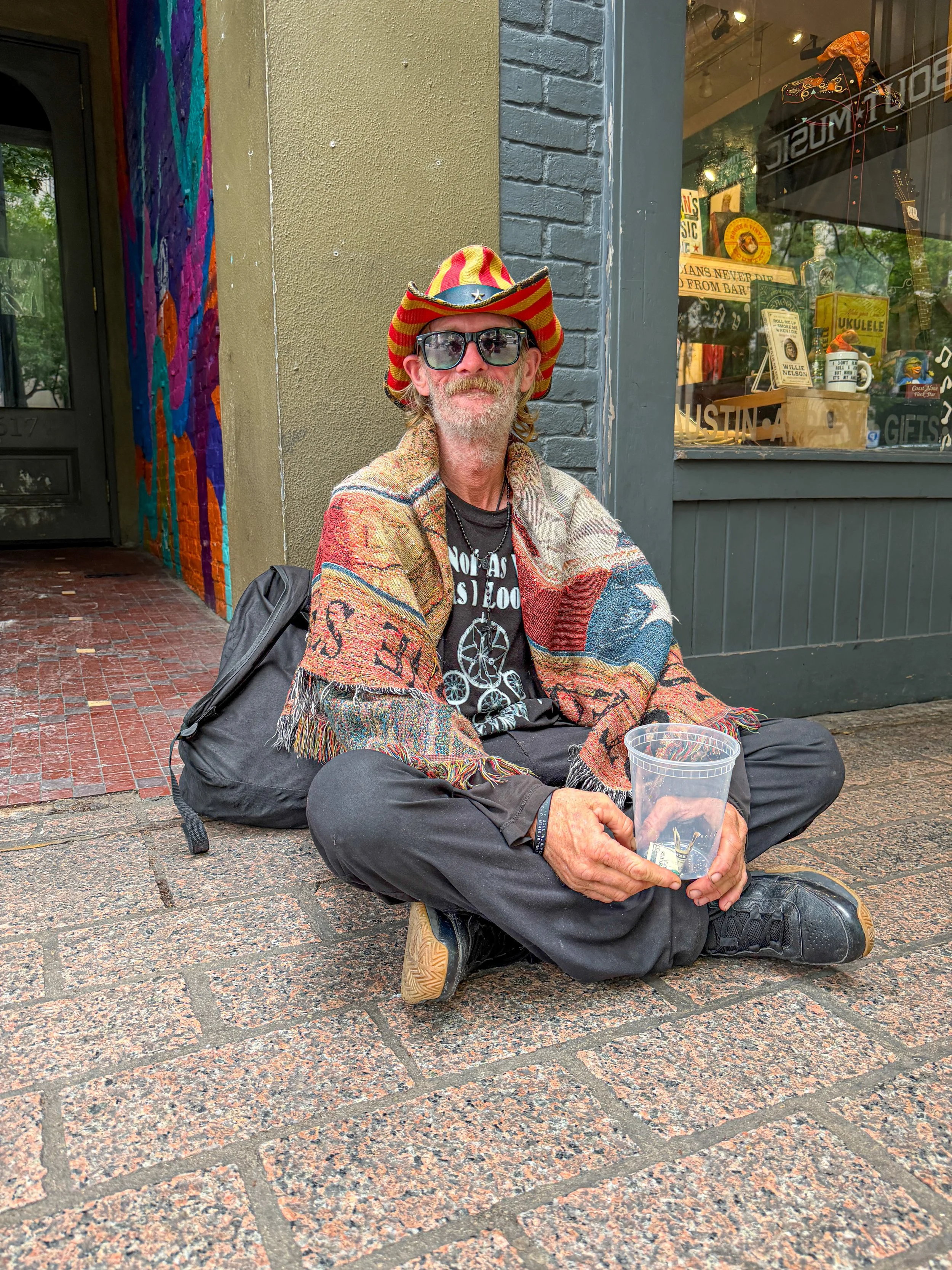  Homeless man that I go to talking to, downtown on Congress Avenue.  He was genuinely excited that I recognized that he had the same name as the bass player of Van Halen (Michael Anthony).  